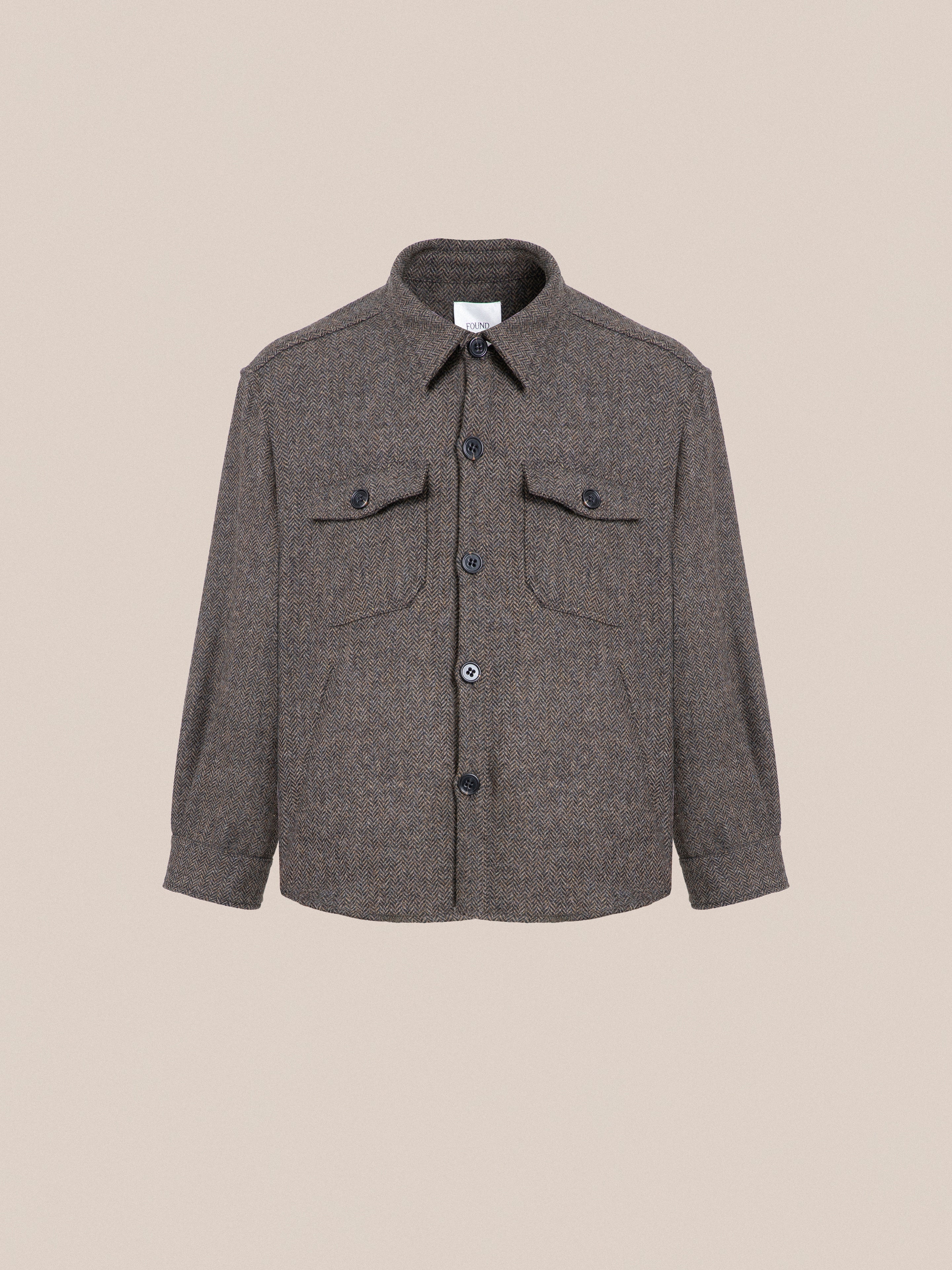 A Raven Herringbone Overshirt with buttons on the front, ideal for layering.