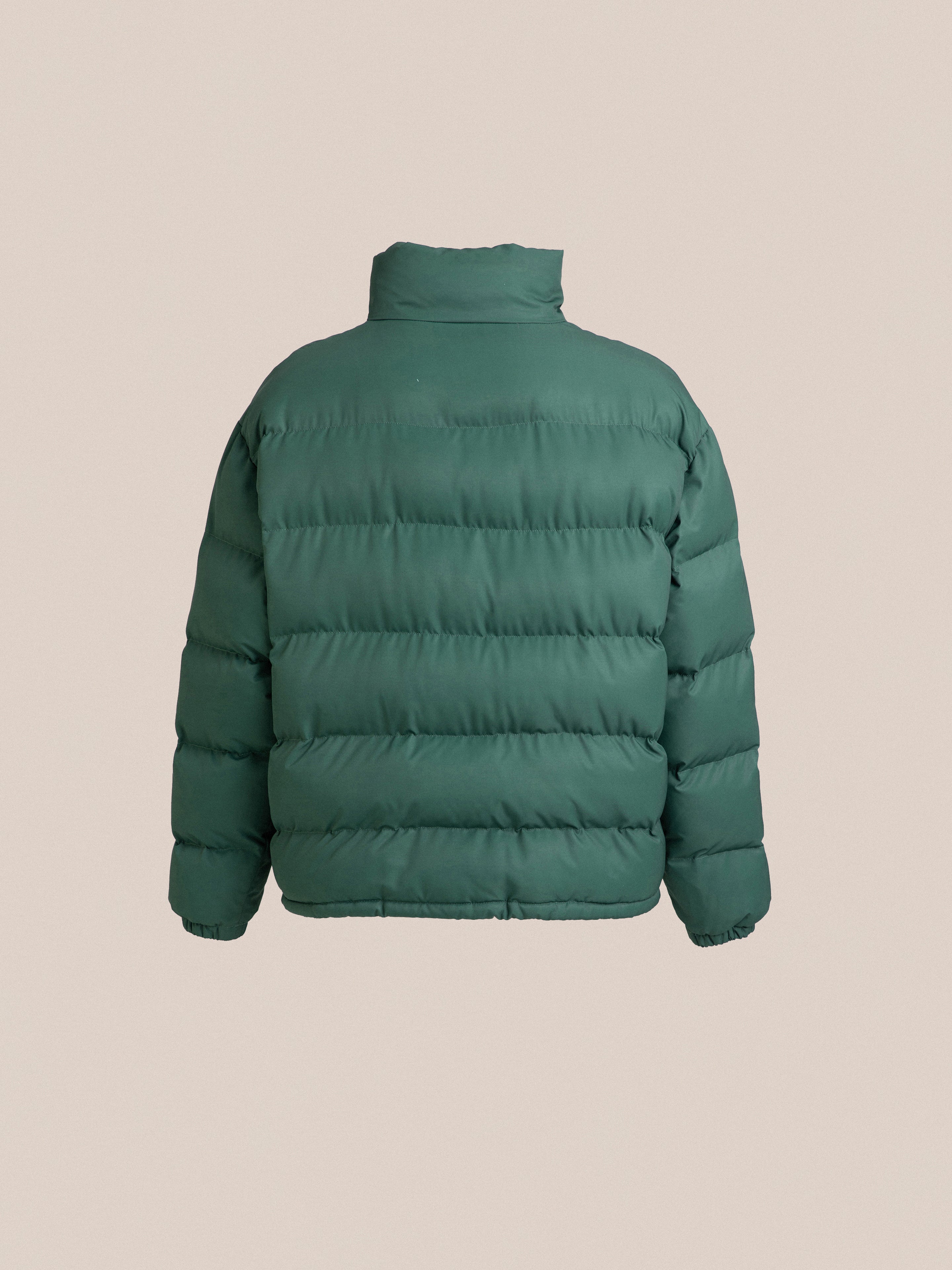 The back view of a Found Laurel Pine green hue puffer jacket.