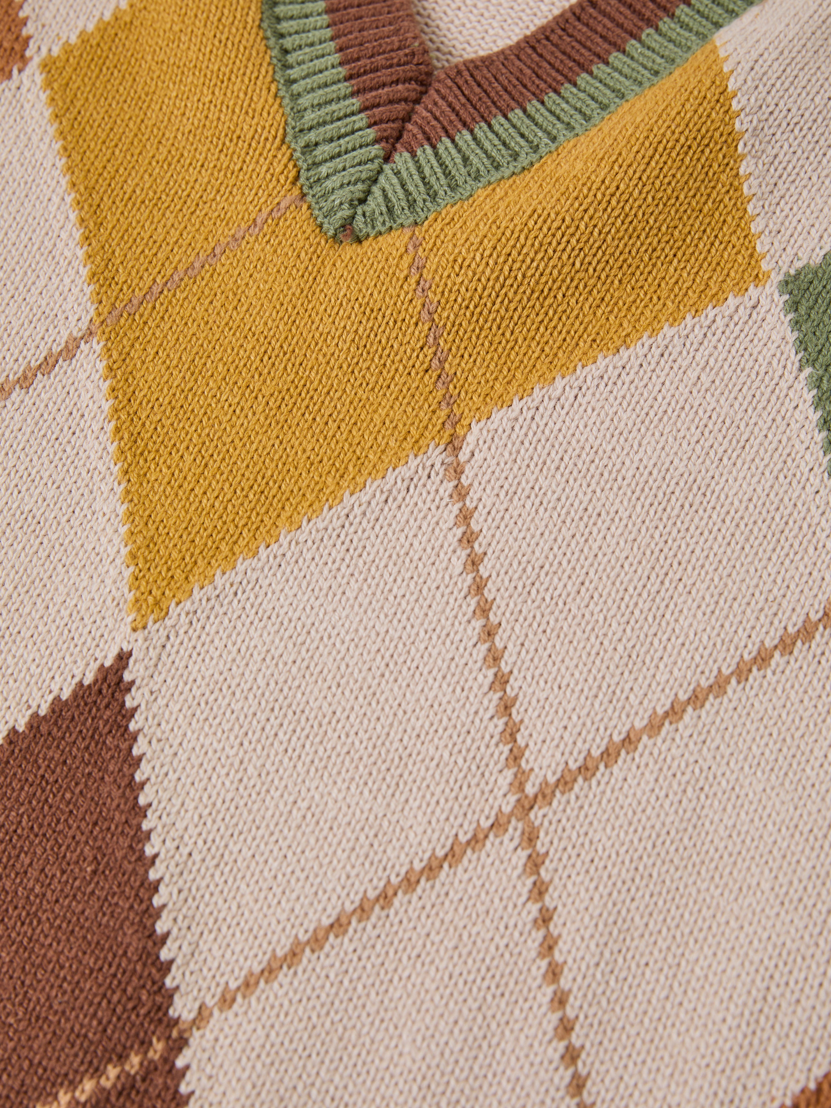 Close-up of a knitted fabric featuring an Argyle Knit Vest-inspired checkerboard pattern by FOUND, with beige, yellow, brown, and green squares.