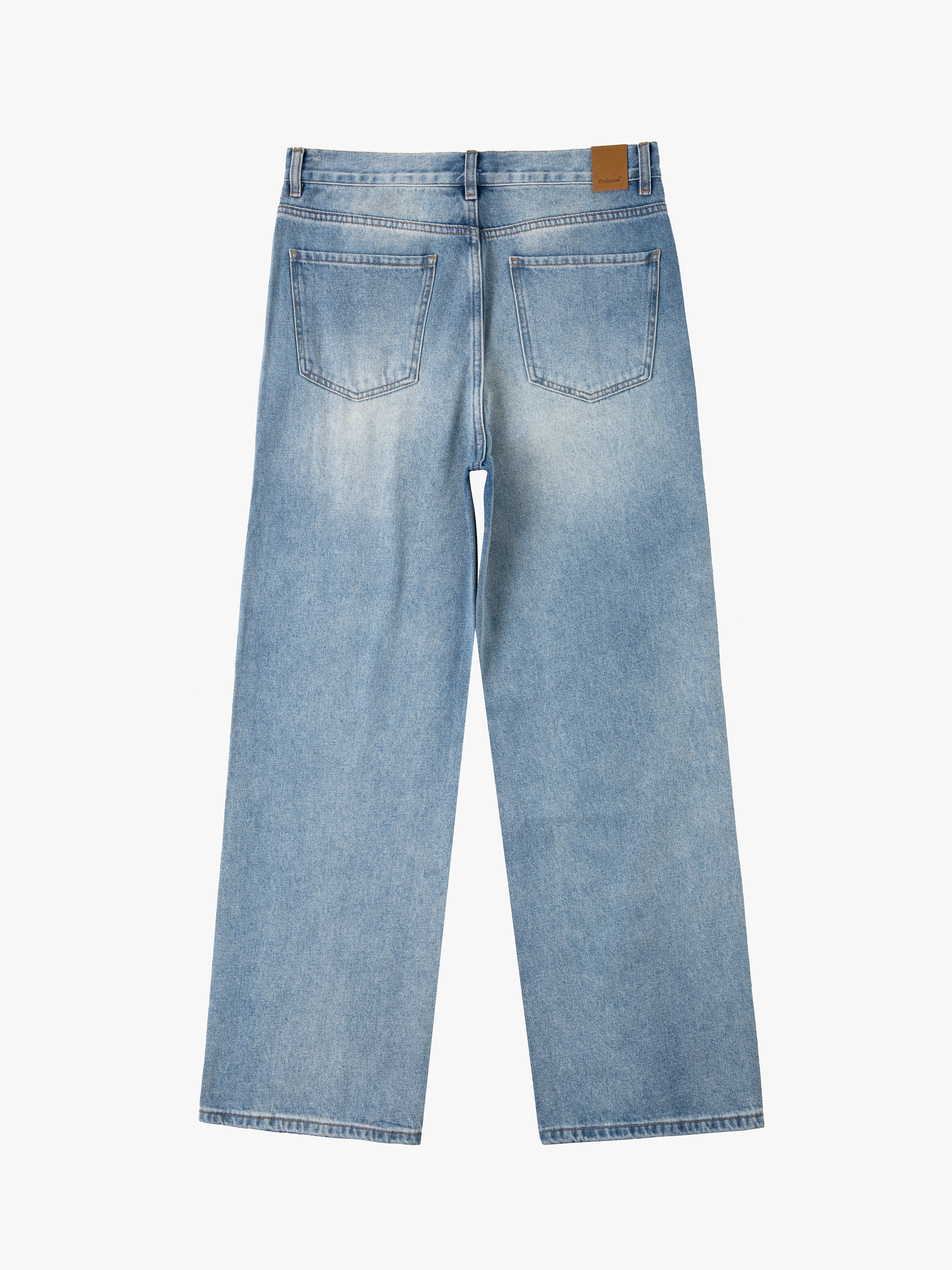 Back view of the Mix Patch Jeans from Profound, a pair of light blue wide-leg jeans made from denim cotton. They feature two large back pockets and a small brown leather patch on the waistband, enhancing their vintage appeal.