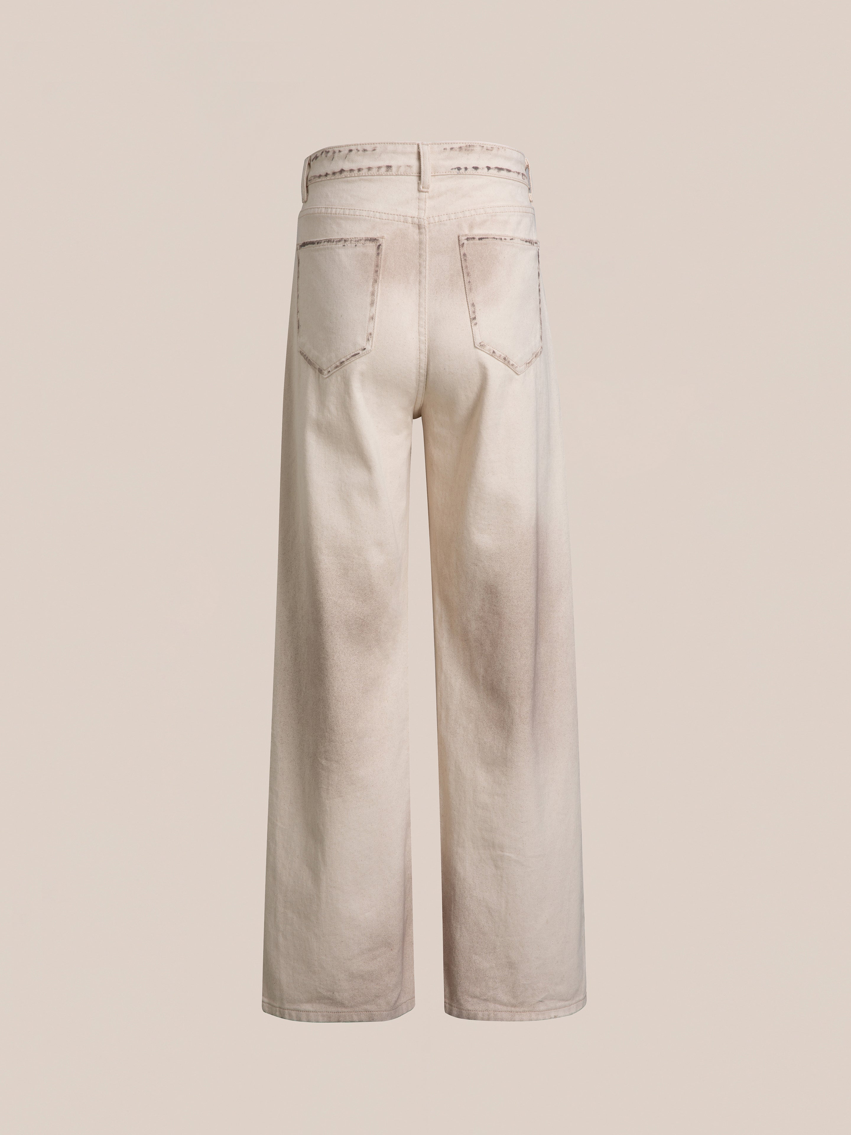 Back view of a pair of Lacy Baggy Jeans by FOUND in a light beige color with light distressing and two back pockets.