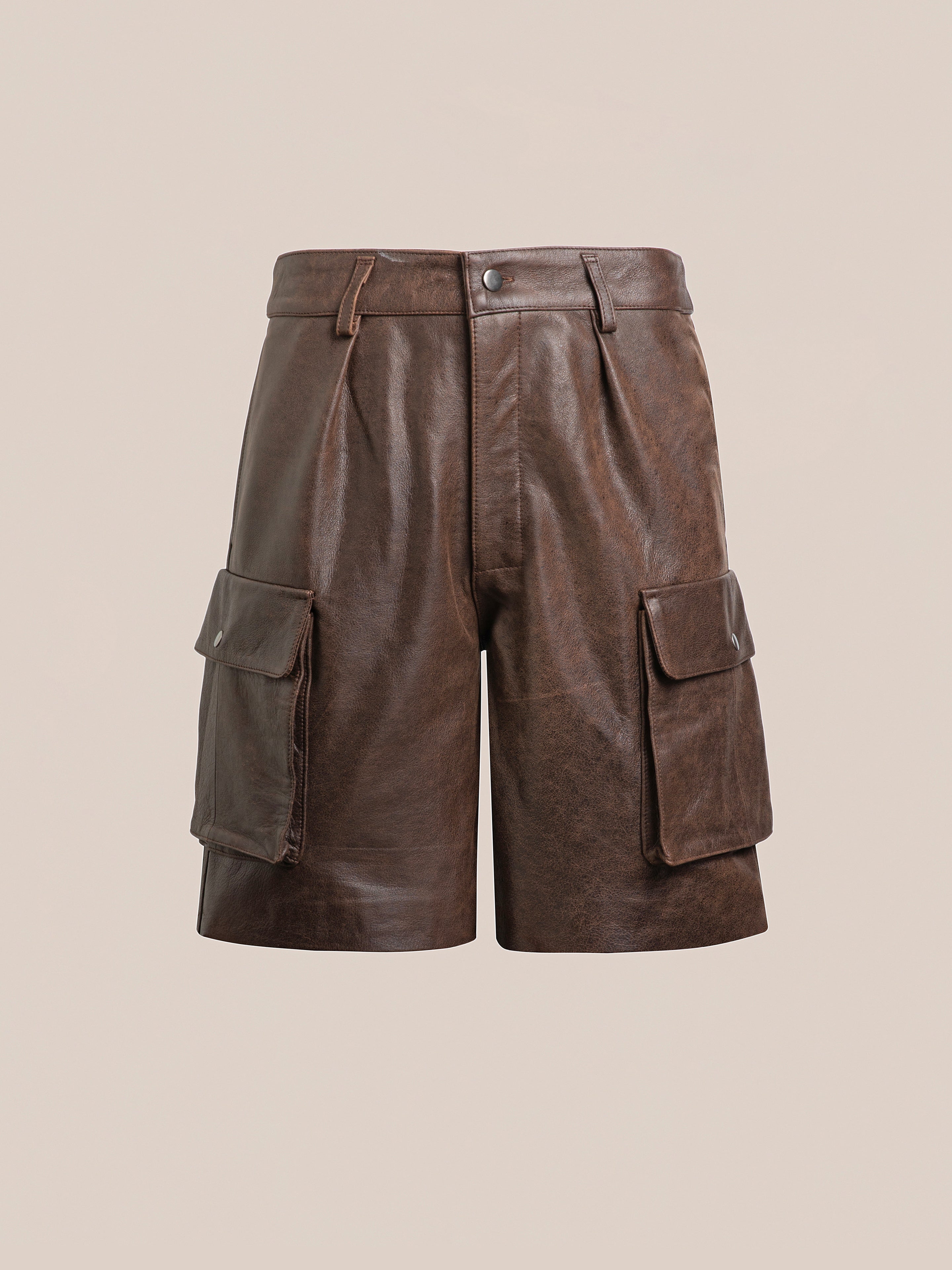 FOUND's Dusk Distressed Genuine Leather Cargo Shorts combine utilitarian roots with modern style, showcasing pleats and two large front pockets against a plain background.