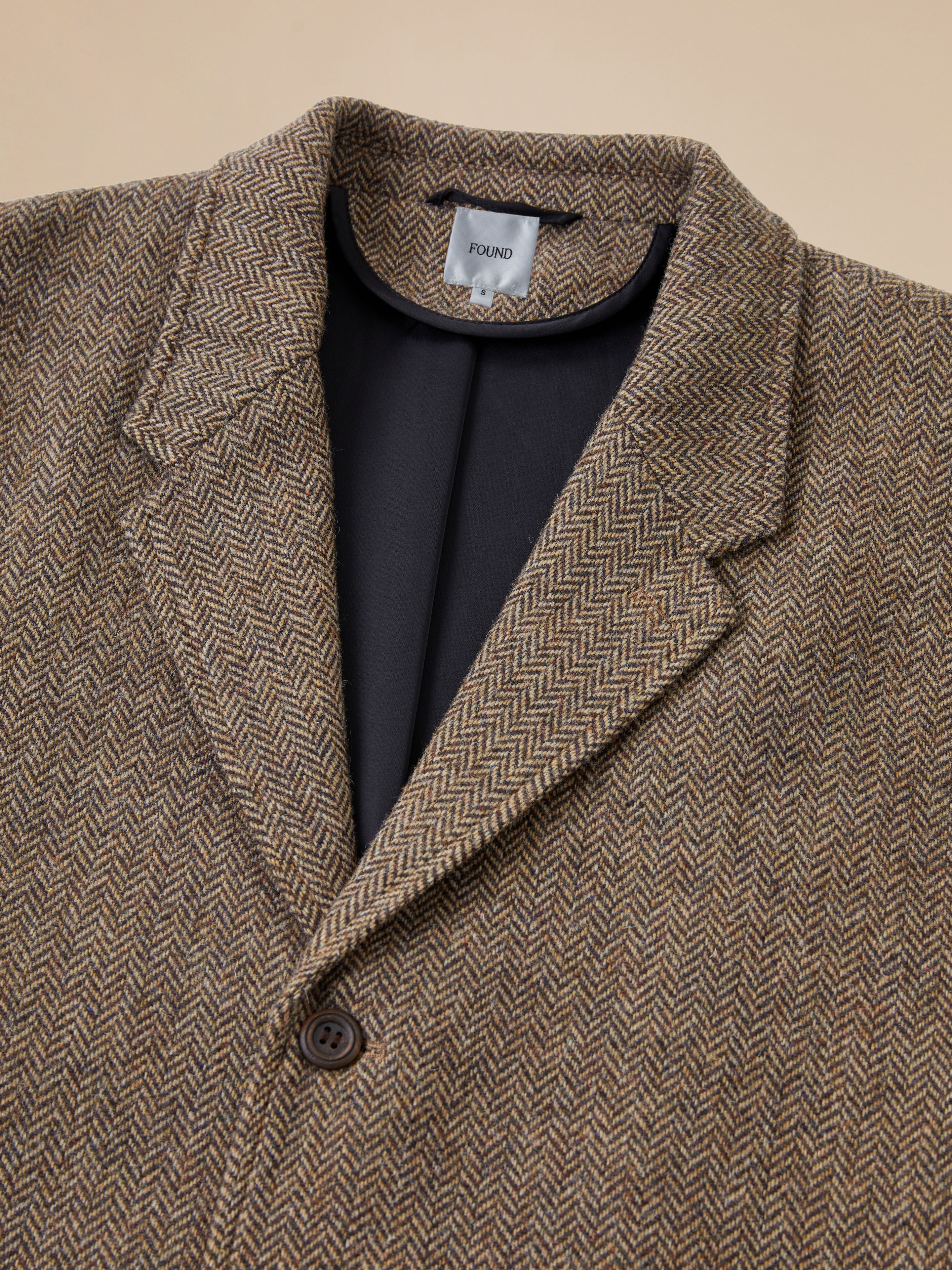 A close up of a Found Elm Tweed Long Top Coat.