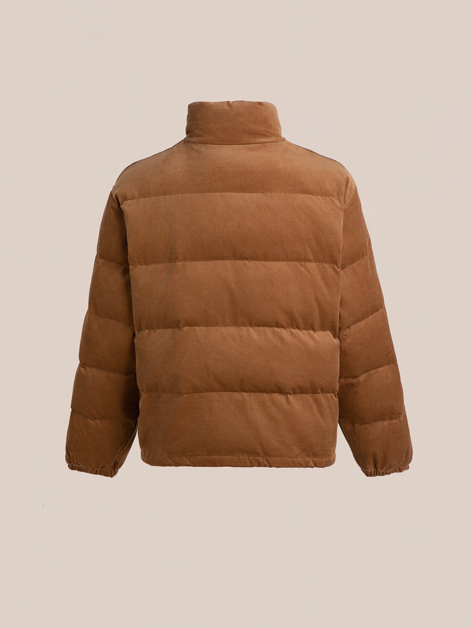 A versatile tan Corduroy Puffer Jacket by FOUND showcases its quilted design, with a high collar and elastic cuffs, in a rear view.