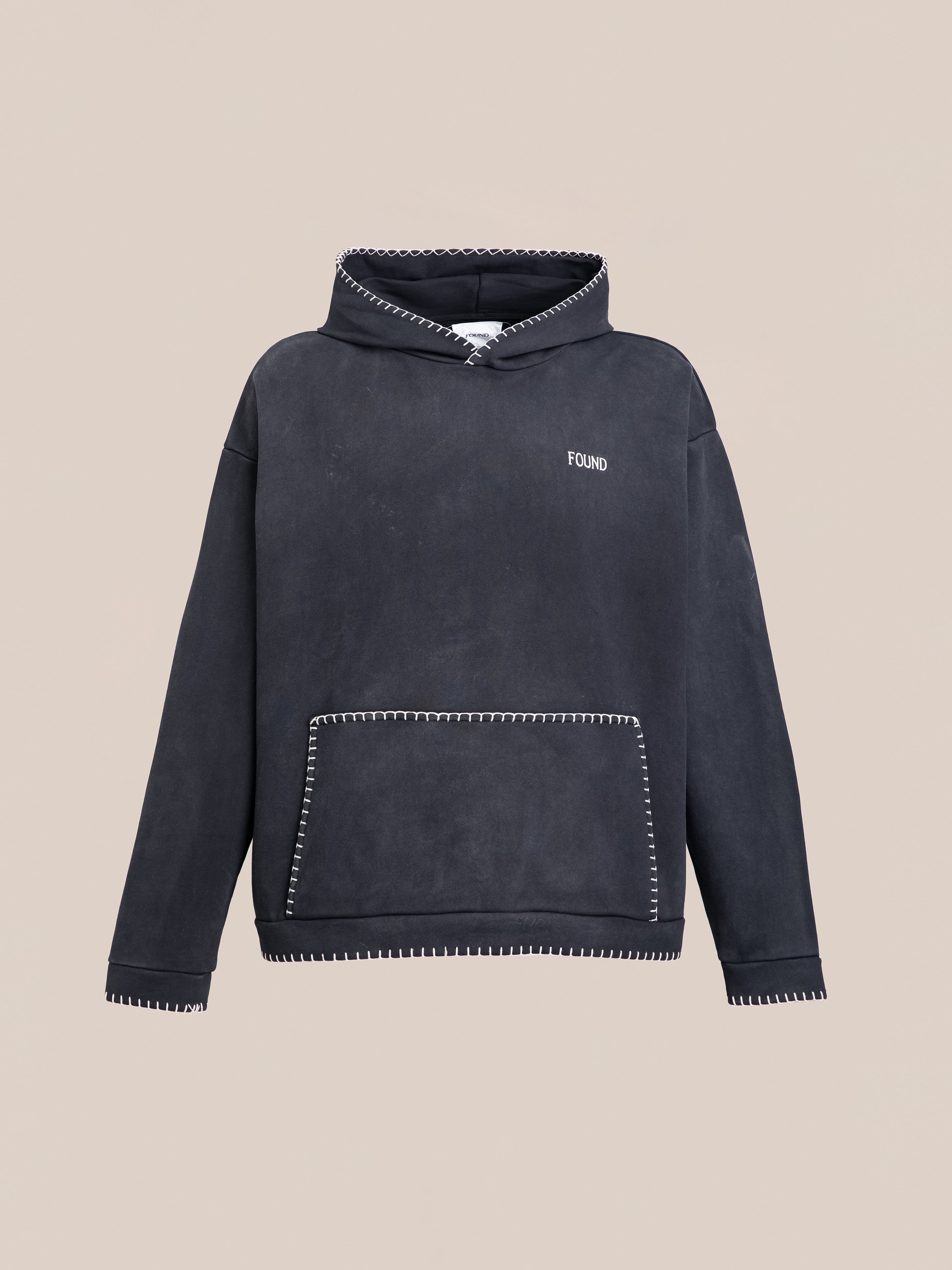 The Stitched Border Distressed Logo Hoodie by FOUND features a contrasting stitched border and displays the word "FOUND" elegantly embroidered on the left chest. Made from French Terry Cotton, it also includes a convenient front pocket.