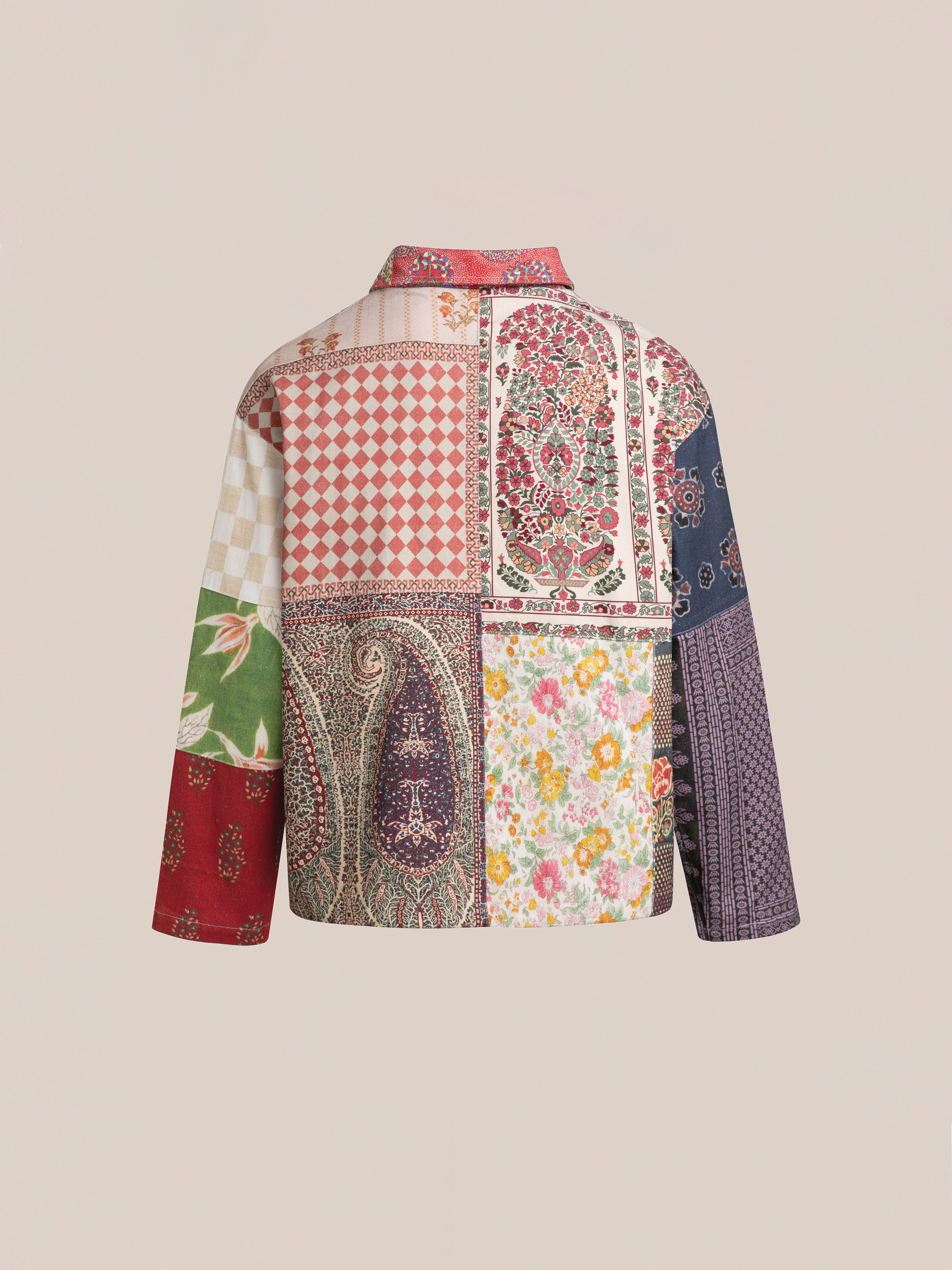 The Tapestry Twill Jacket by FOUND showcases a long-sleeve design with a patchwork of multiple patterns, including floral, paisley, and geometric prints in various colors against a neutral background. Crafted from lightweight cotton twill for enhanced comfort.