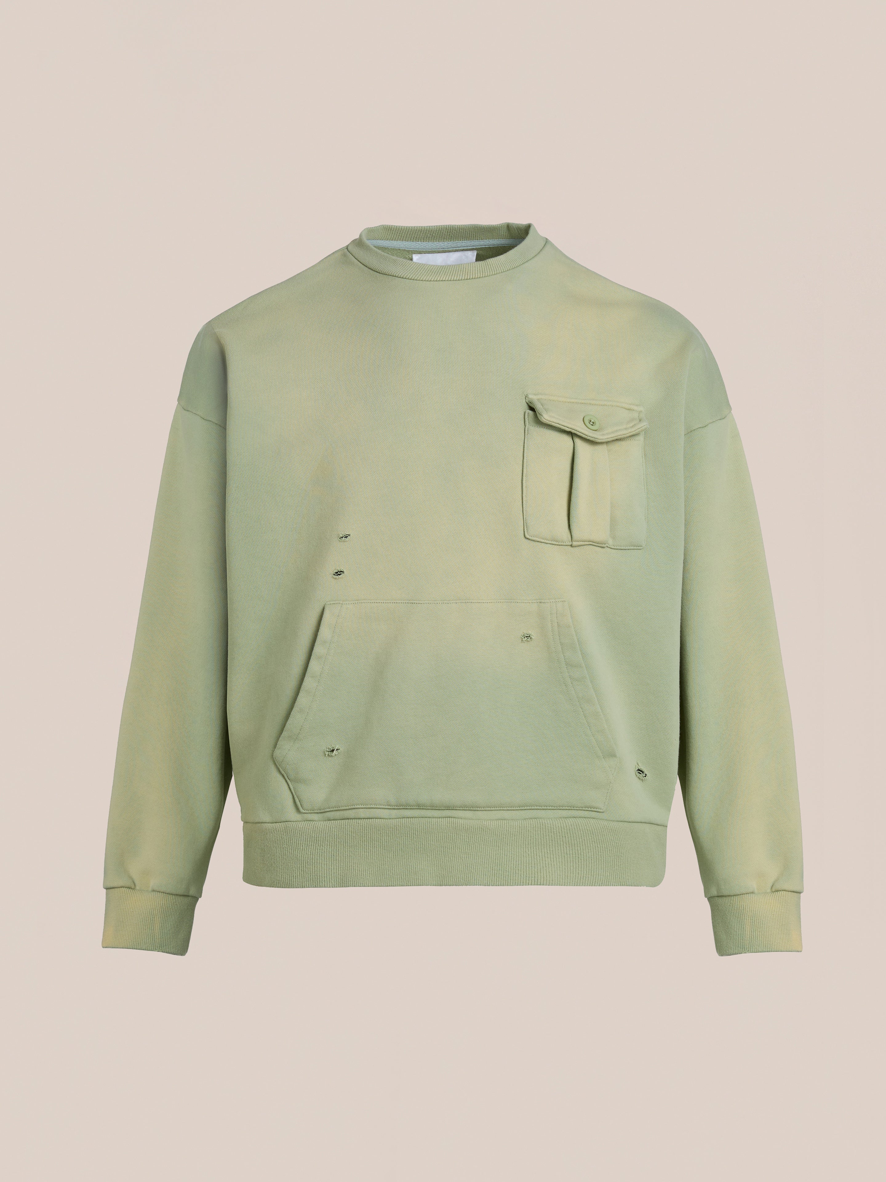 The Faded Pocket Crewneck by FOUND is a heavyweight cotton green sweatshirt with a vintage-inspired, unisex relaxed fit. It features a chest pocket, front pouch, and slightly distressed fabric with small holes.