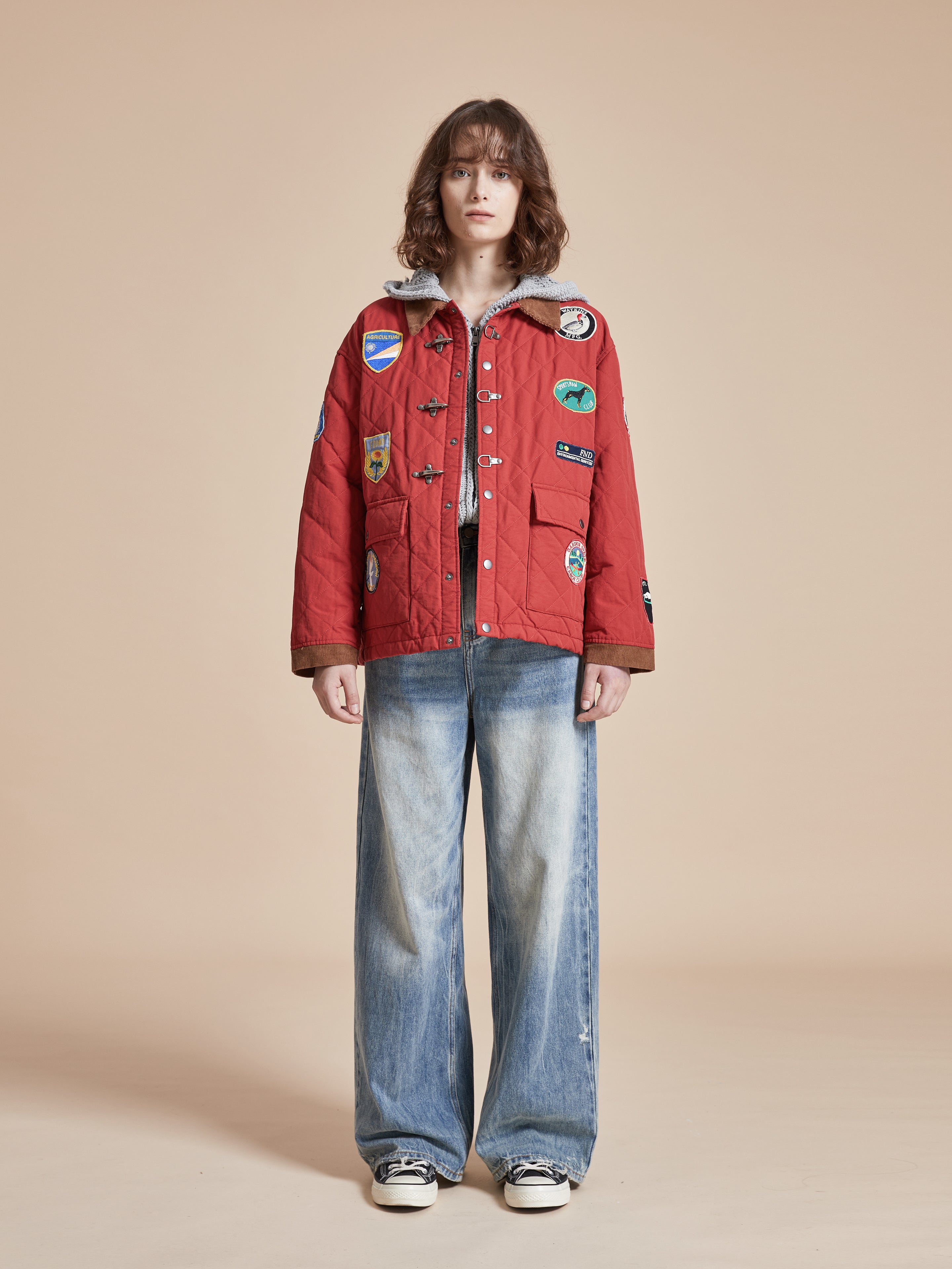 A woman wearing a Farmstead Quilt Patch Jacket by Found and jeans.