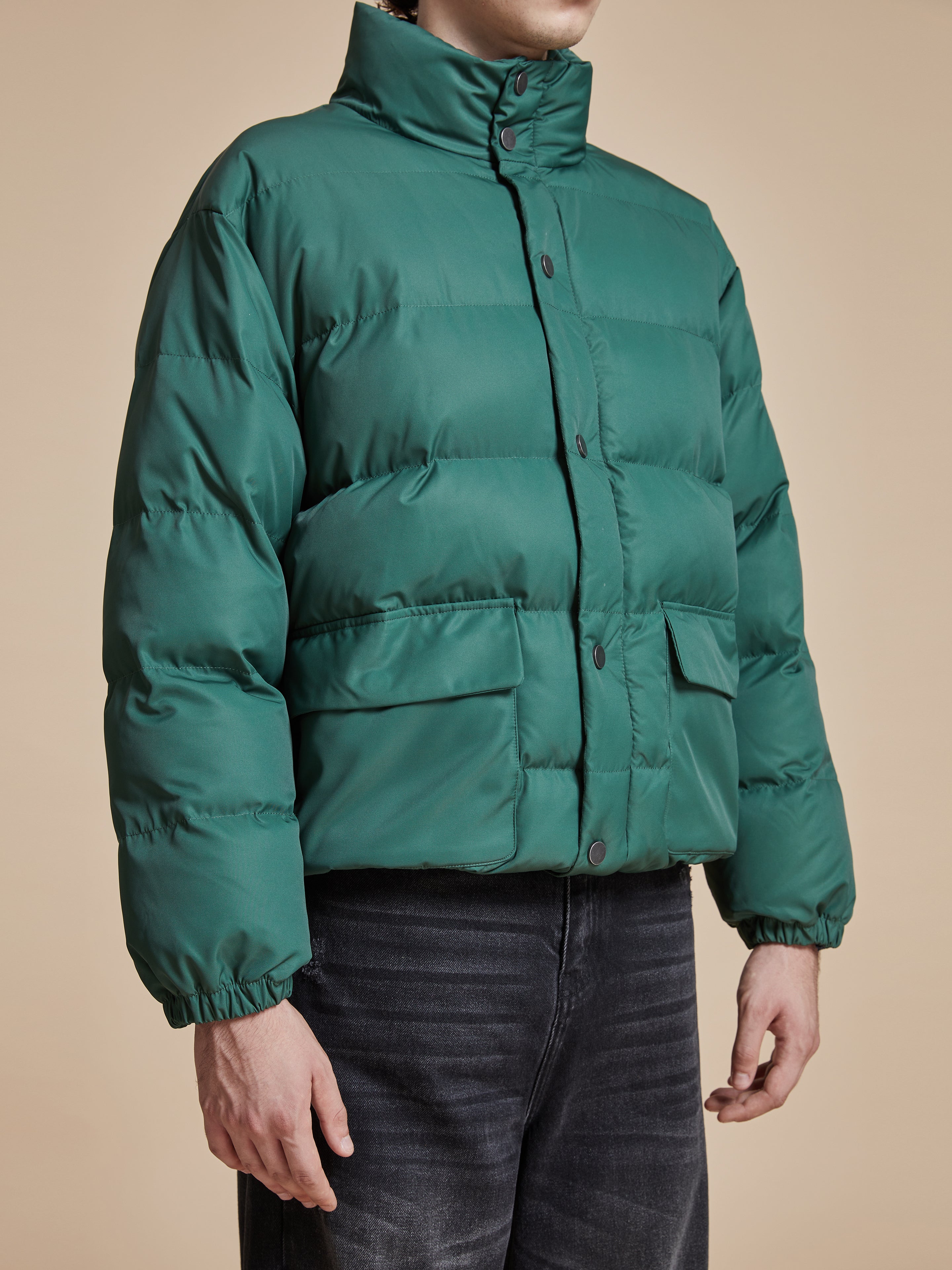 A man wearing a Found Laurel Pine Puffer Jacket.