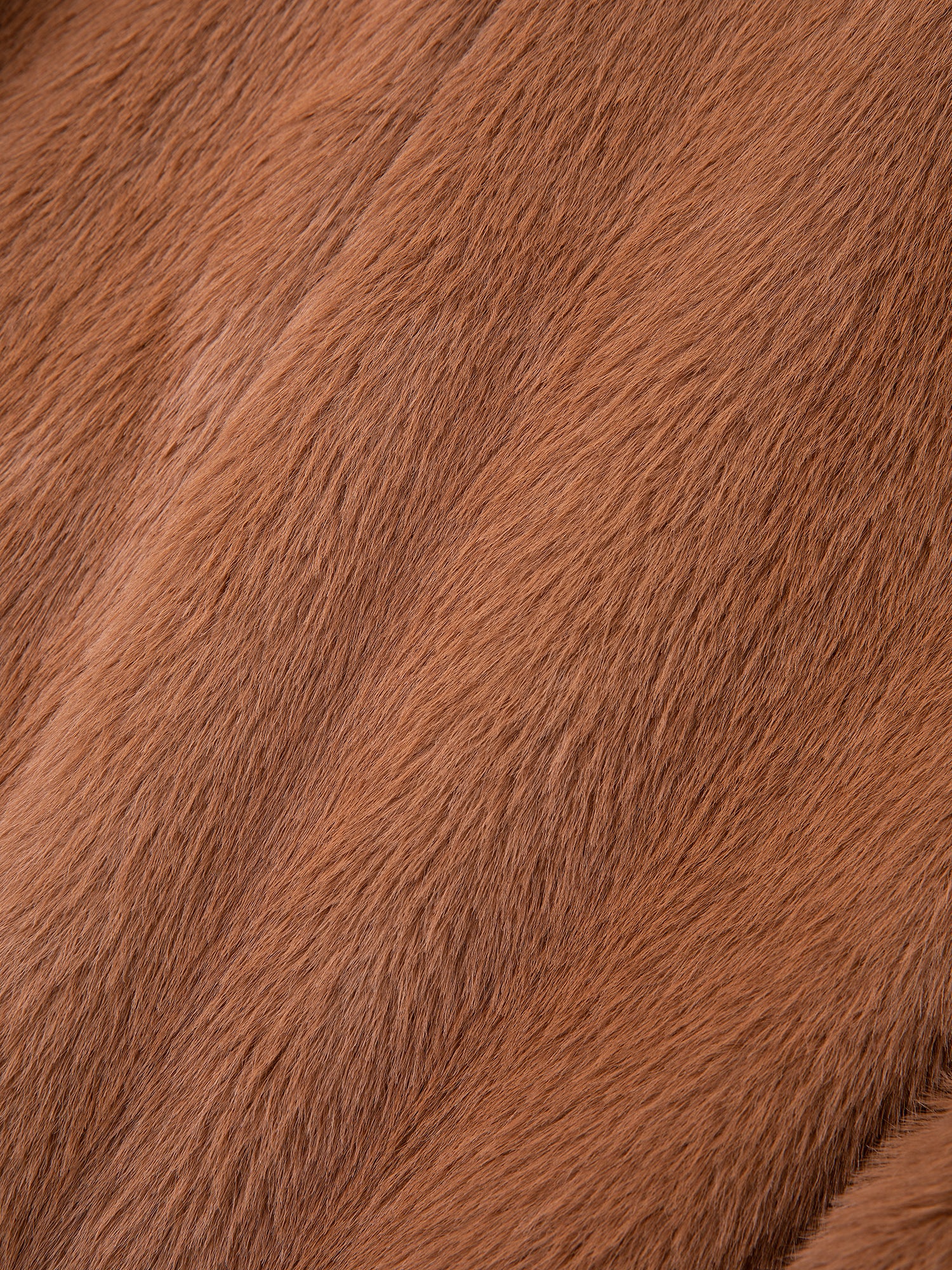 Close-up of a textured brown fur surface, reminiscent of the intricate pattern and fibers in FOUND's luxurious Long Faux Fur Coat.