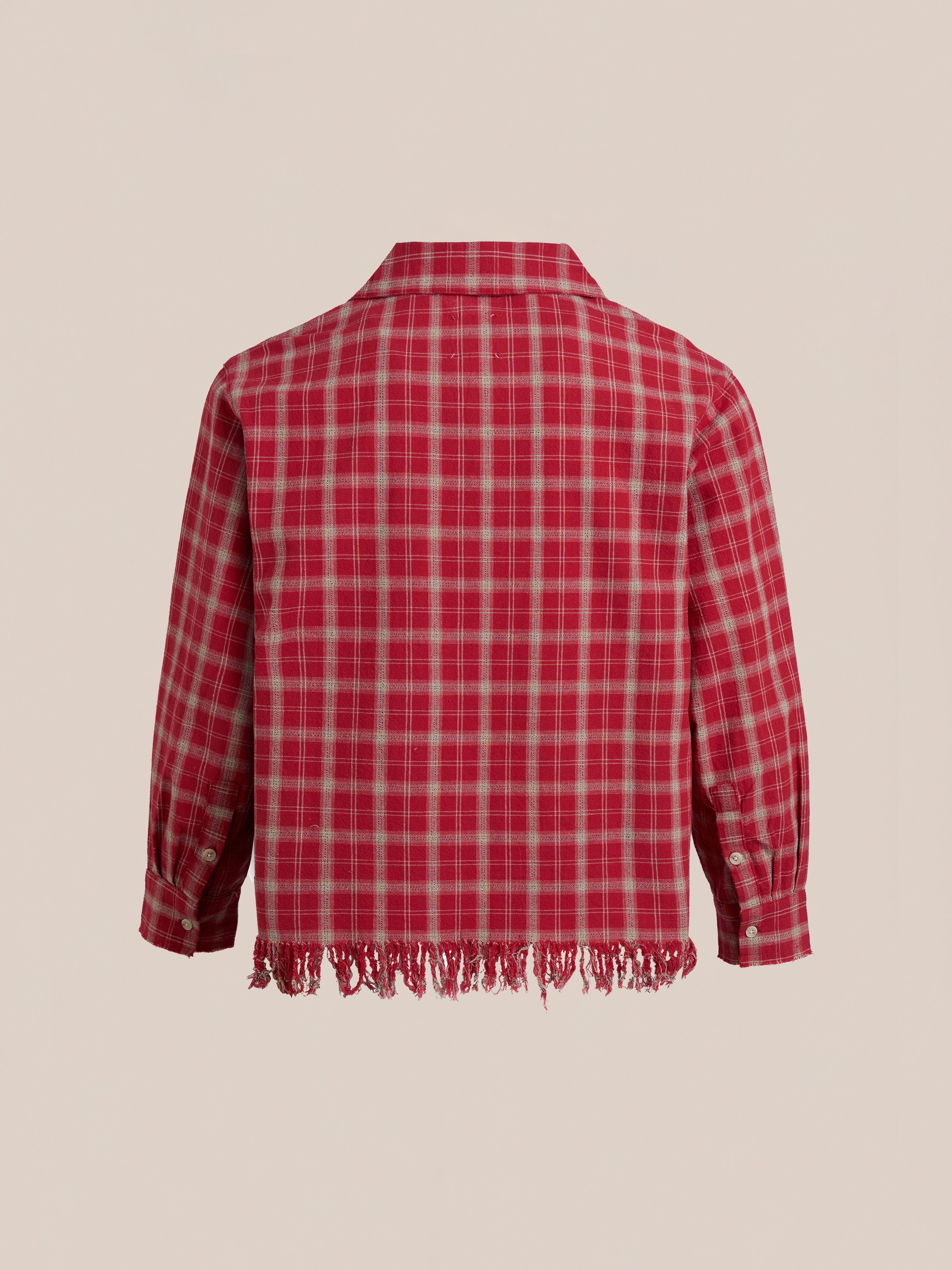 The Raw Cut Fringe Plaid Camp Shirt by FOUND features long sleeves, buttoned cuffs, and a frayed hem, crafted from soft brushed cotton for flannel comfort, shown from the back.