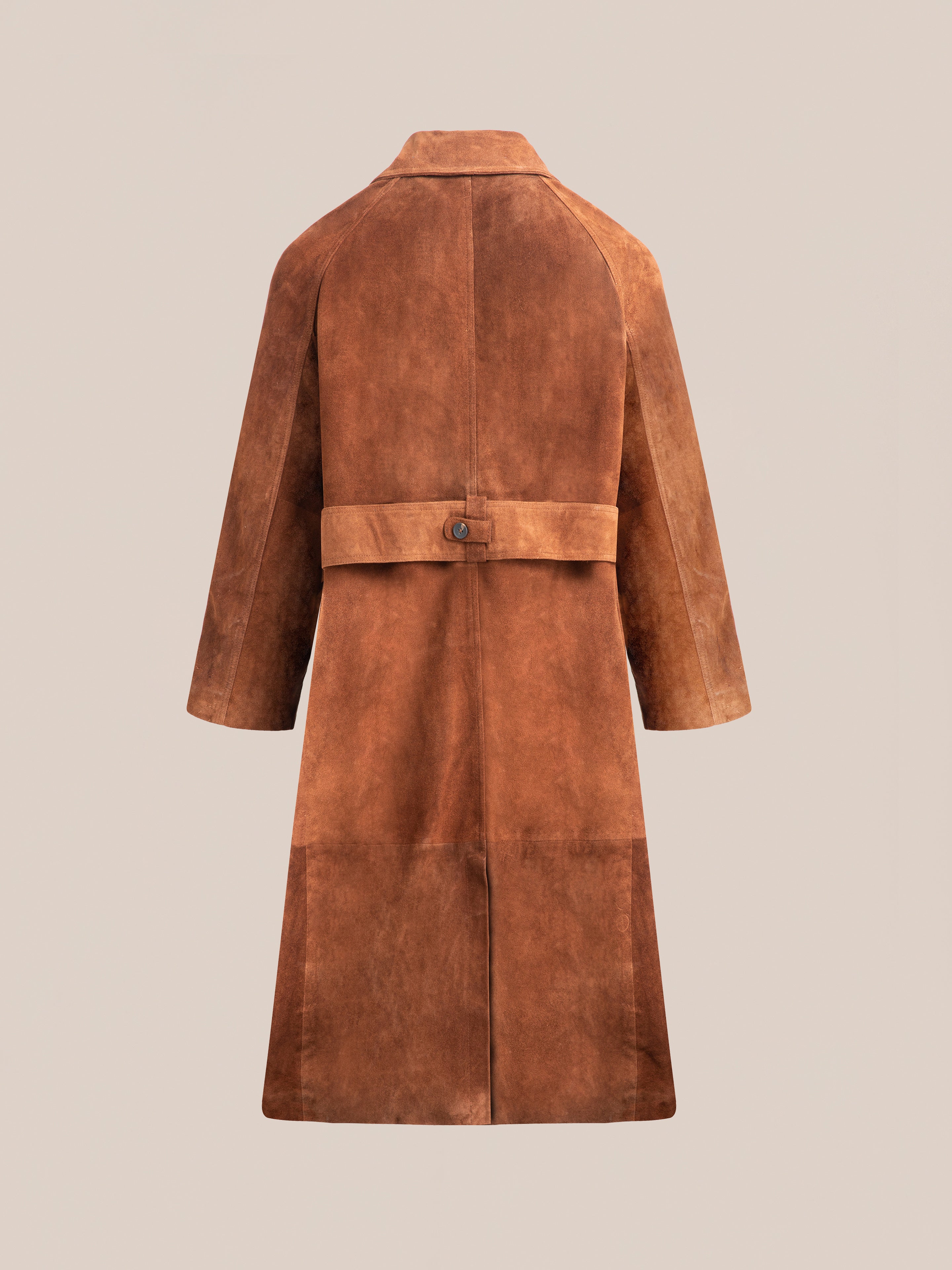 Back view of the Suede Leather Trench Coat by FOUND in brown, shown on a beige background, with a waist belt featuring a buttoned strap and wide sleeves.