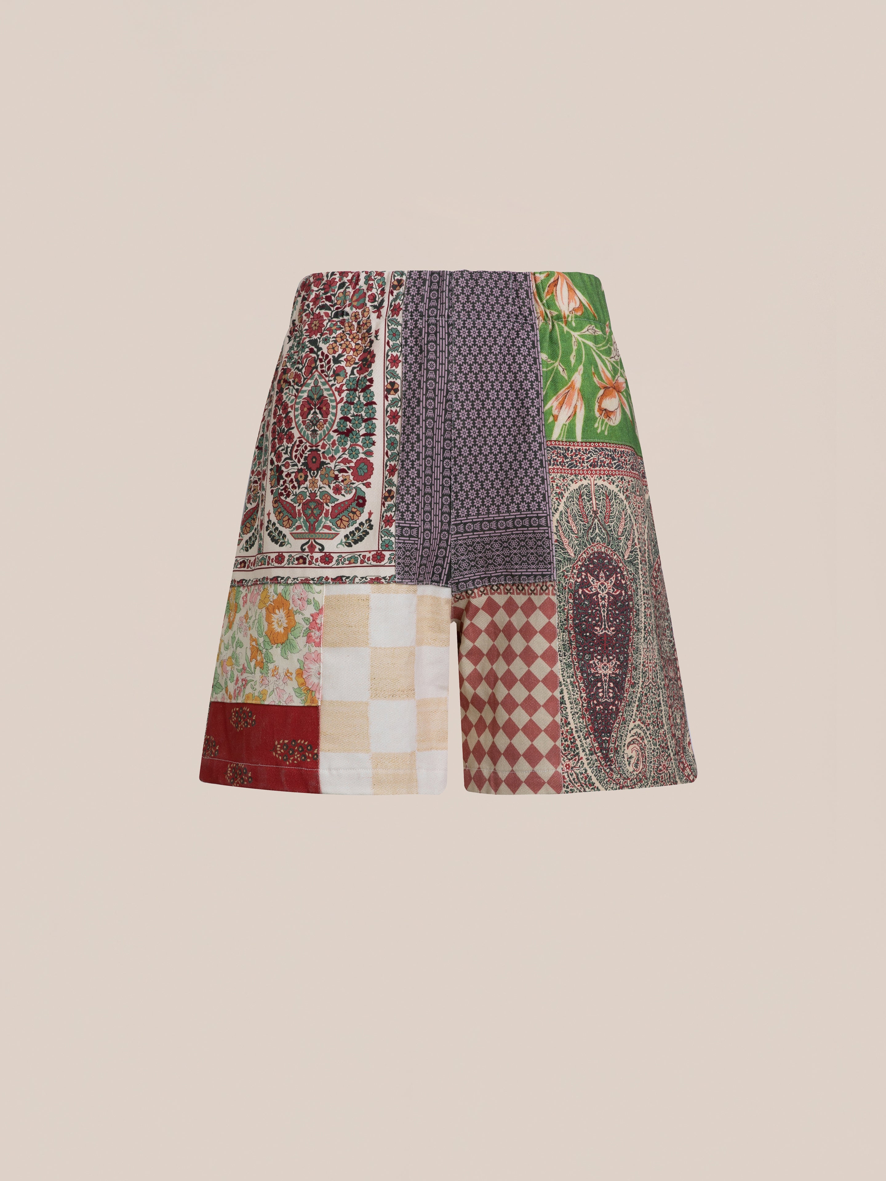 A pair of Tapestry Twill Shorts by FOUND featuring various patterns and colors, including floral, checkered, and paisley designs.