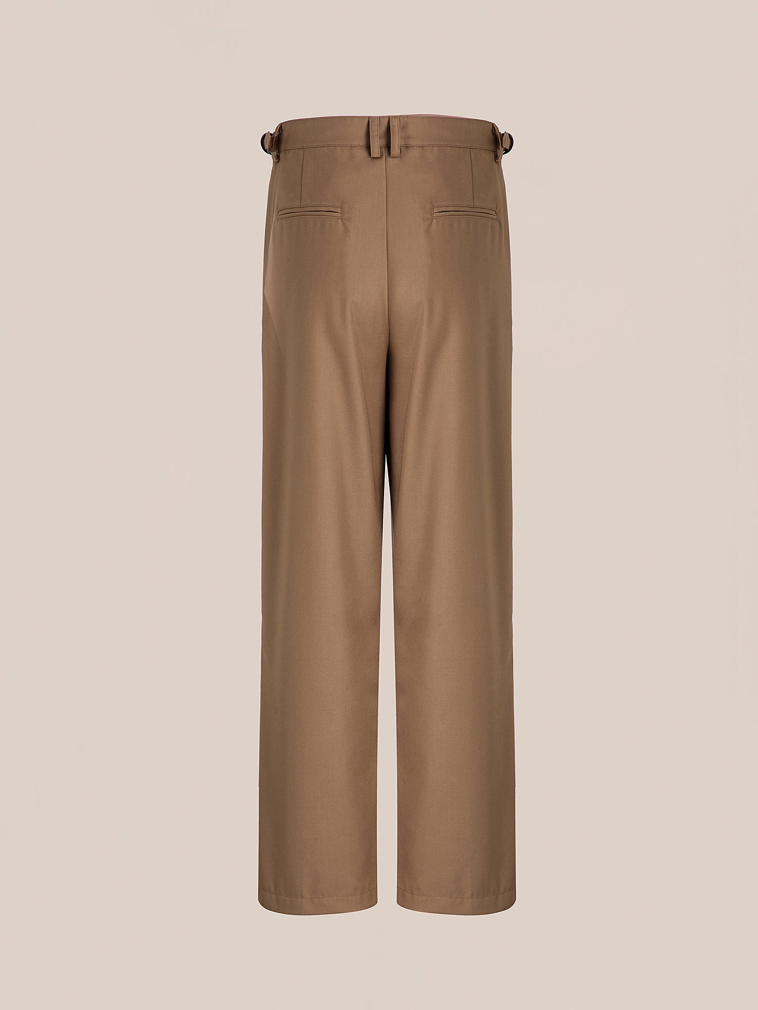 Rear view of FOUND's Pleated Trousers in brown, featuring a high-rise fit with belt loops, back pockets, and a double pleated silhouette, set against a plain background.