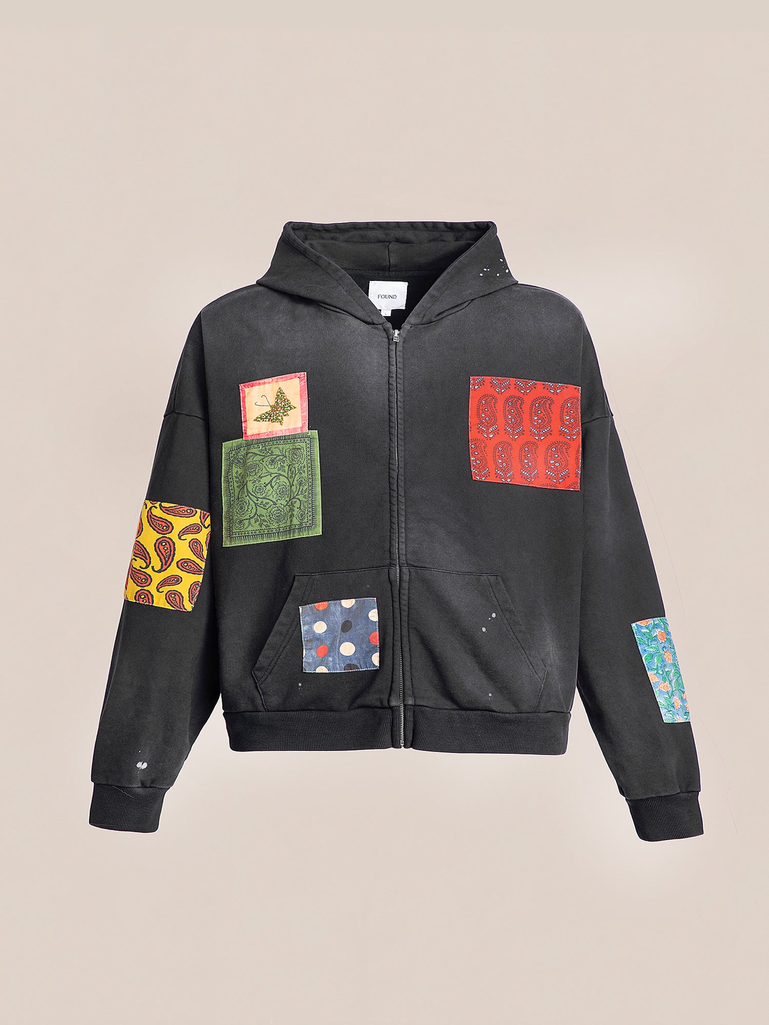 Introducing the Tapestry Patchwork Zip Up Hoodie by FOUND, a faded black oversized piece embellished with vibrant patchwork designs across the front and sleeves.