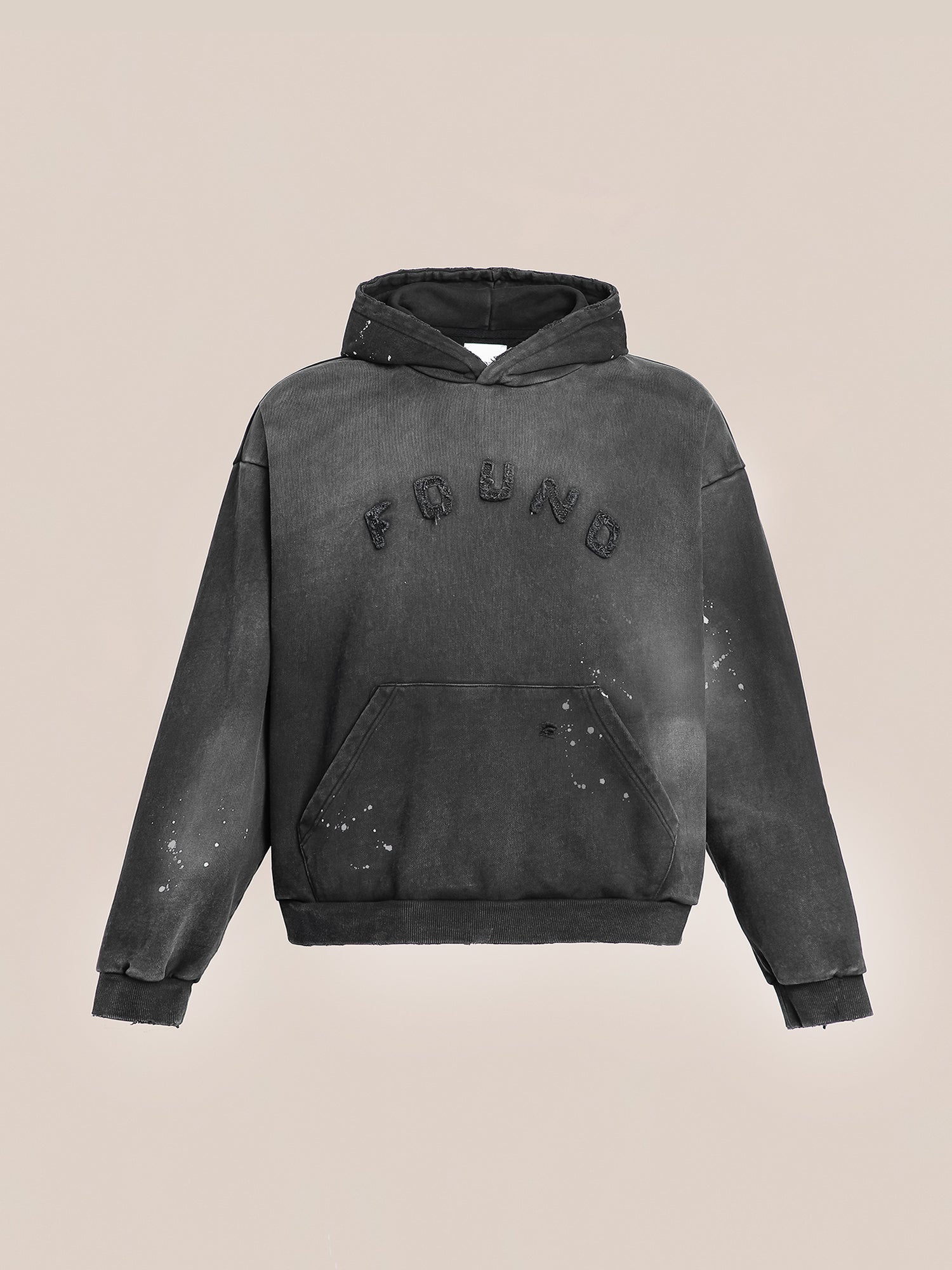 A classic black "Logo Patch Hoodie" from FOUND, designed with a vintage distressed style and made with soft French terry cotton. It features a front kangaroo pocket and prominently displays the word “FRND” raised on the chest.