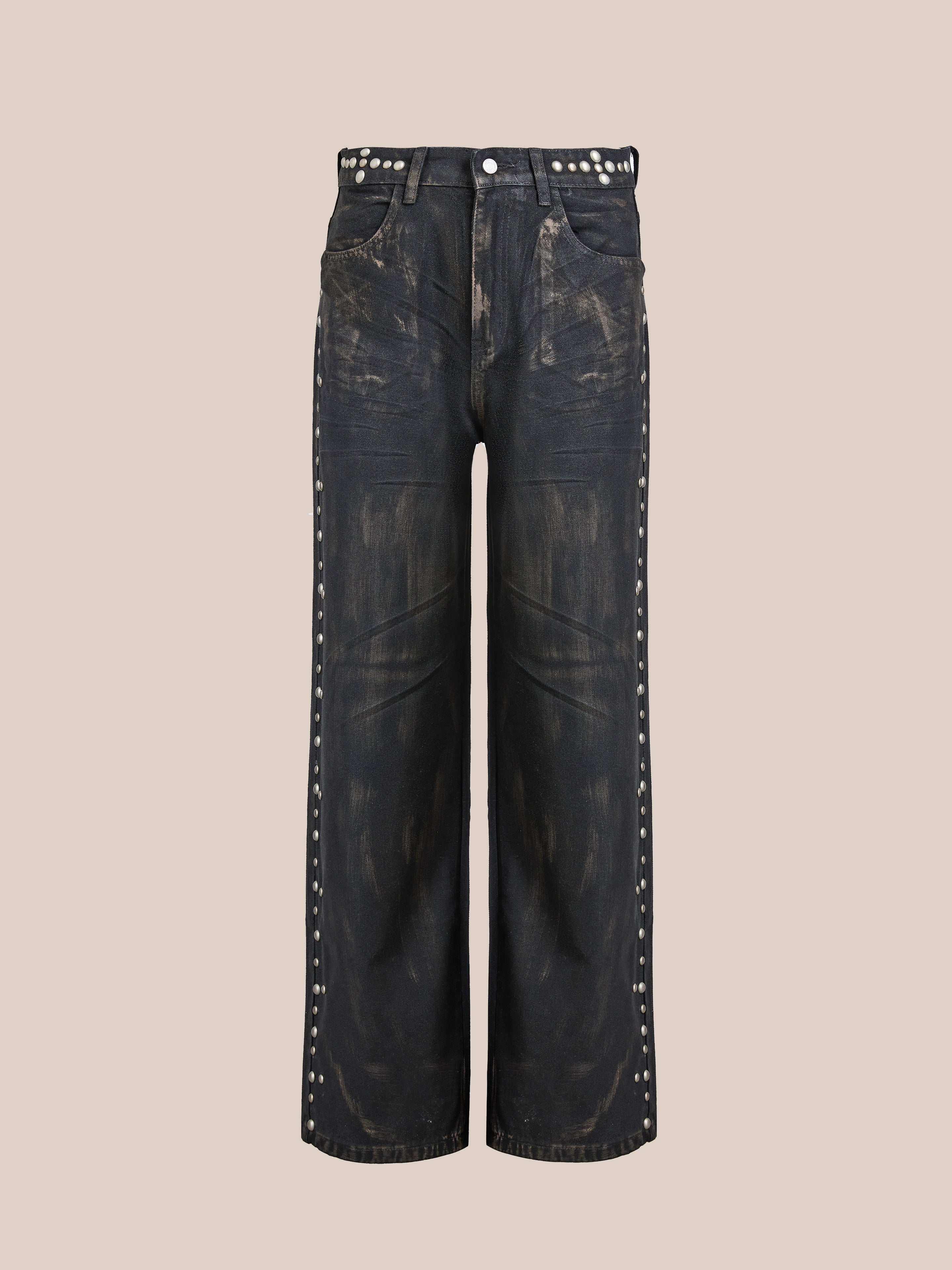 FOUND's Waxed Studded Jeans feature a black wide-leg design with distressed texture and antique matte silver studs on the pockets and sides, presented on a plain background.