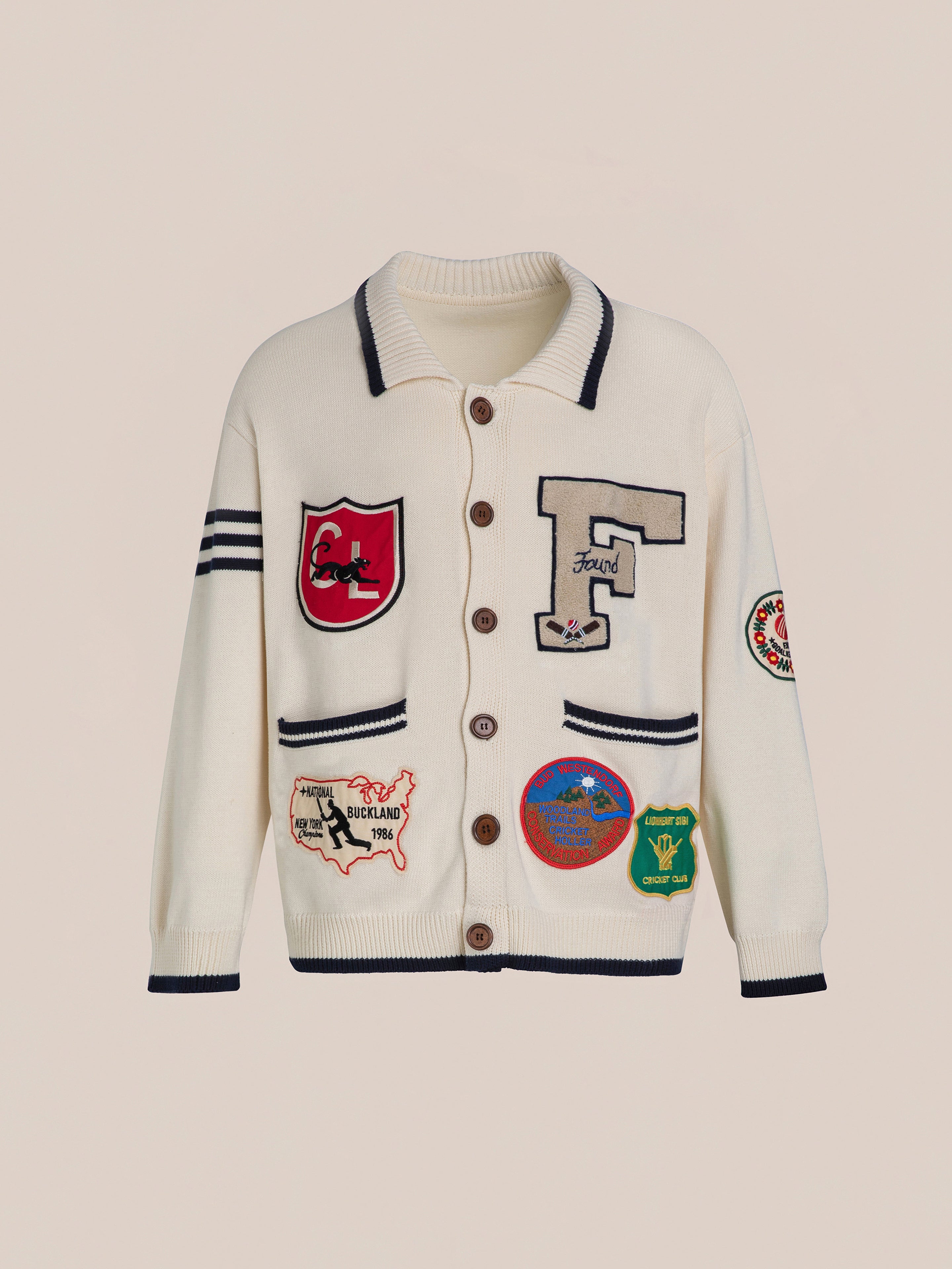 The York Varsity Patch Collared Cardigan from FOUND boasts large buttons and delightful patches like an "F" and assorted motifs. With navy trimming on the collar and cuffs, it offers a preppy style infused with collegiate nostalgia.