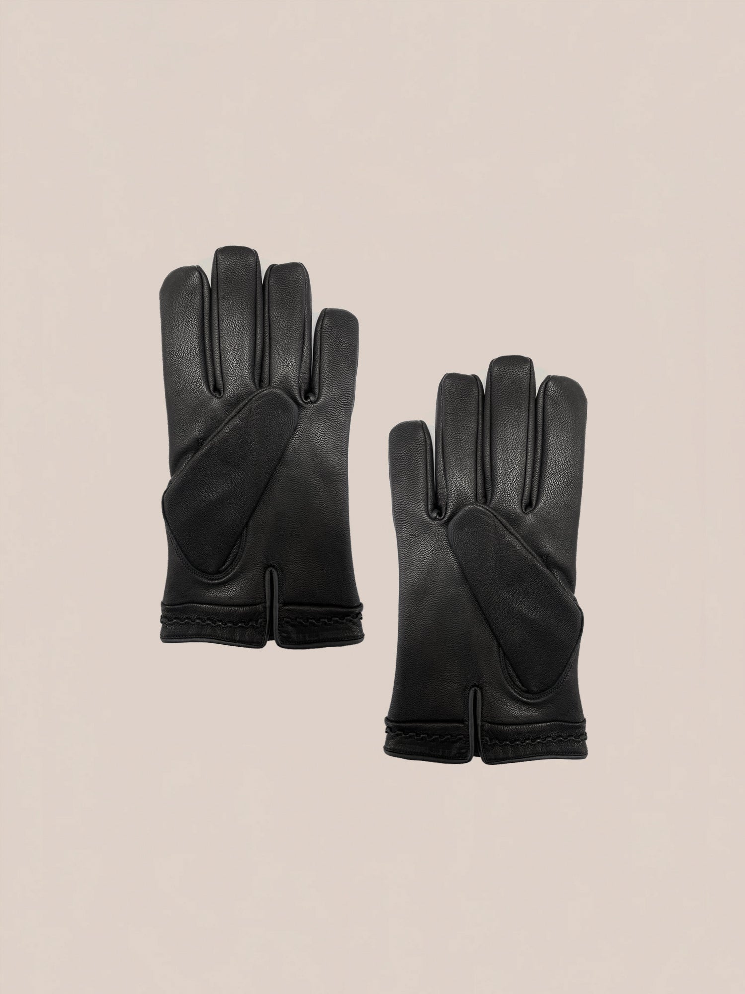 A pair of black Braided Leather Gloves by FOUND featuring reinforced palms and a minimalist design, set against a plain background.