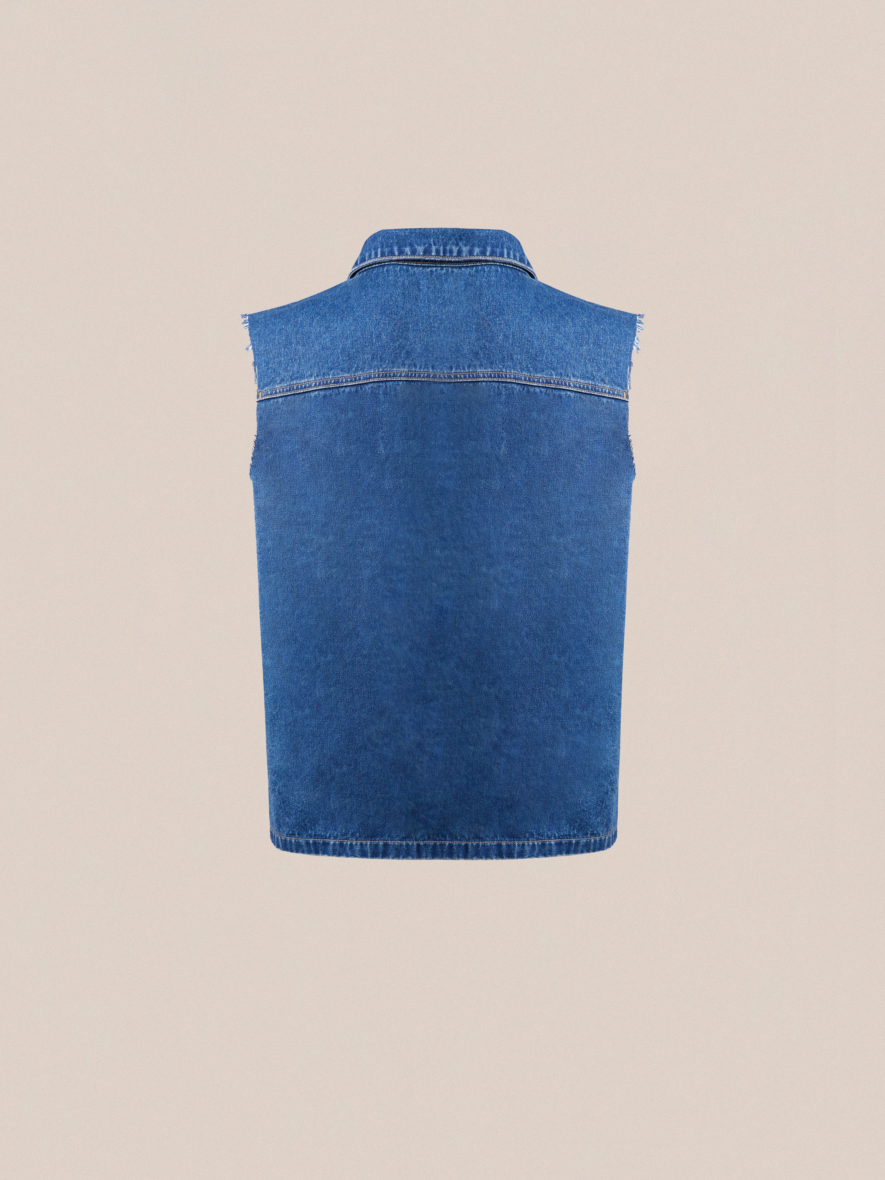 A vintage-inspired, sleeveless Raw Cut Patch Mechanic Denim Vest by Found displayed against a plain beige background.