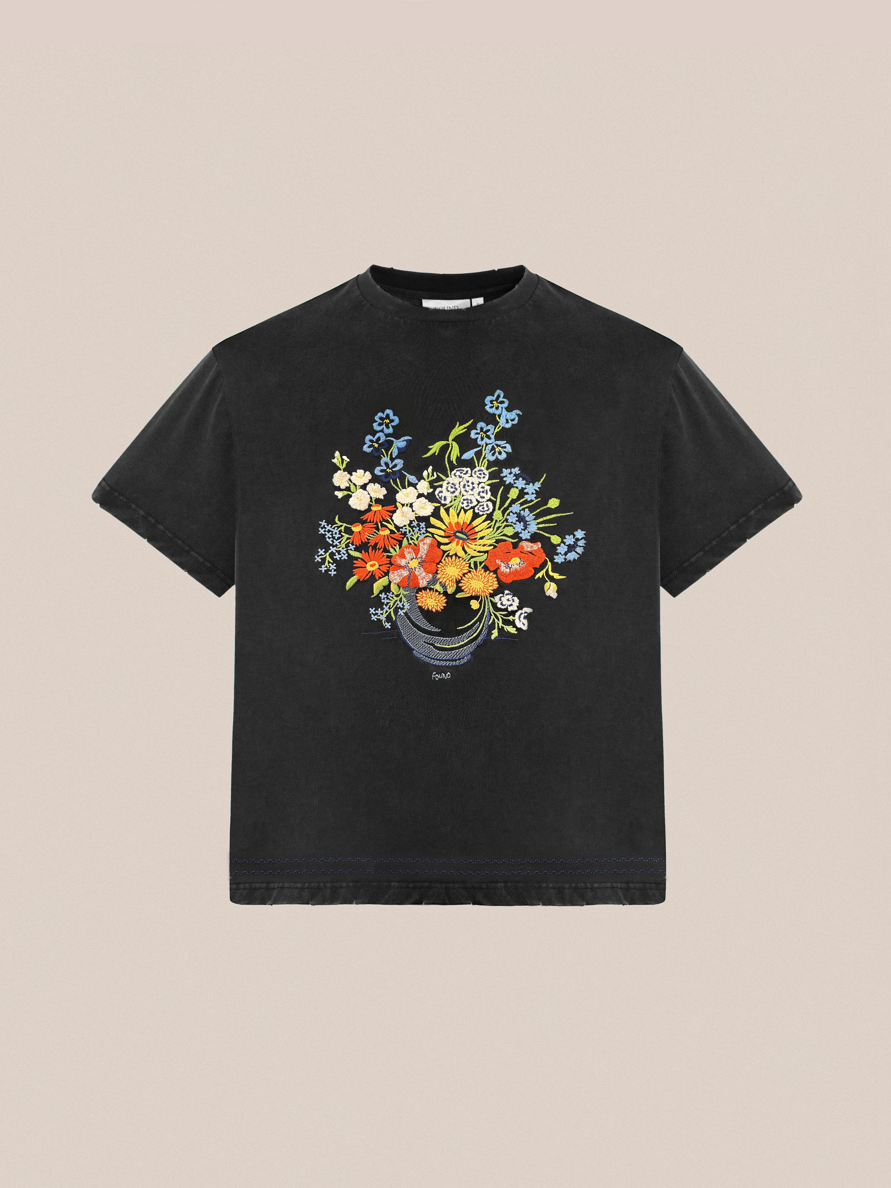 FOUND's Bouquet Flowers Tee is a black T-shirt featuring traditional Punjab Phulkari embroidery with a vibrant floral design on the front.