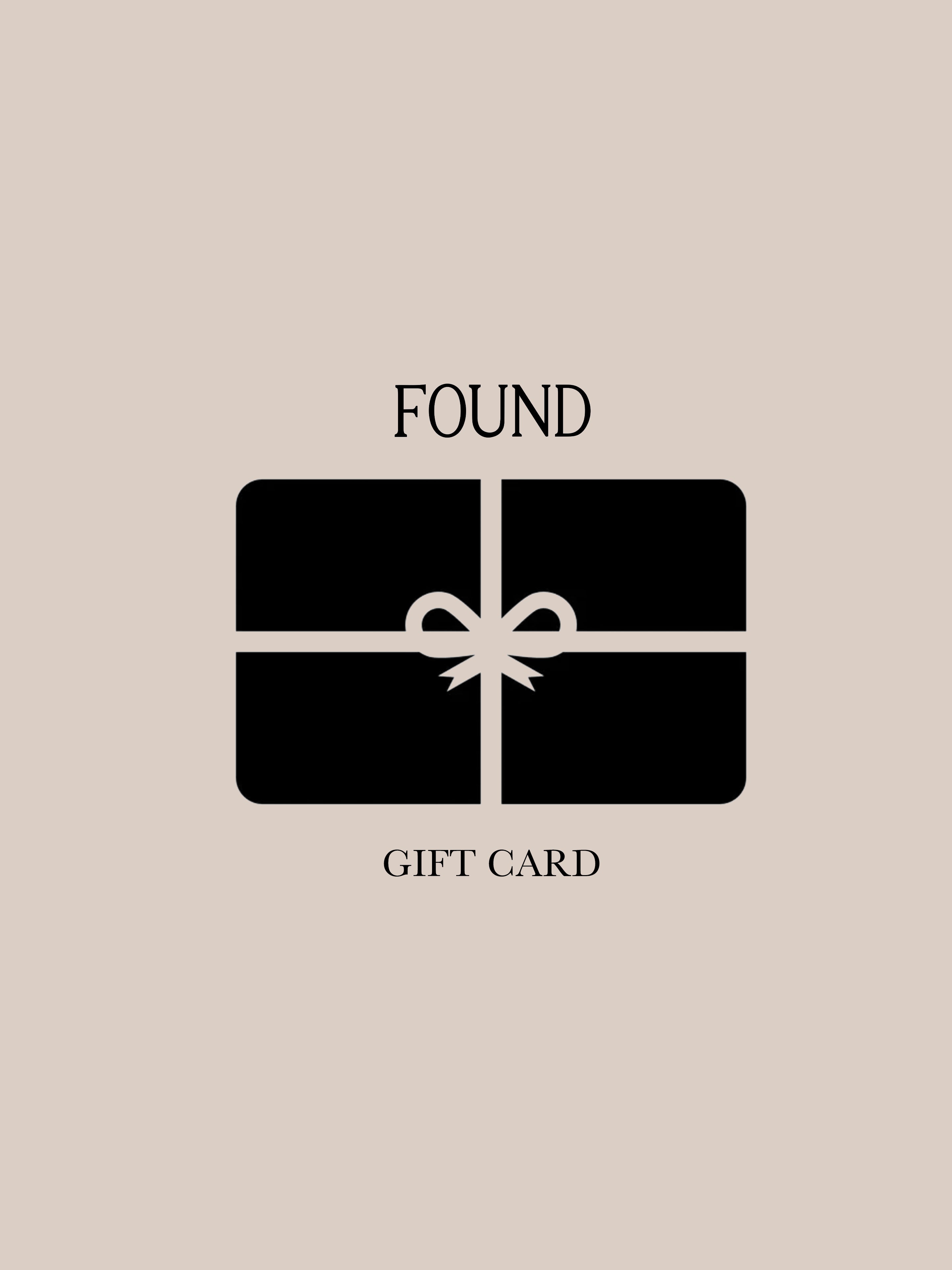 Illustration of a beige background featuring a black gift card from the brand FOUND, adorned with a ribbon and displaying the words "FOUND Gift Card.