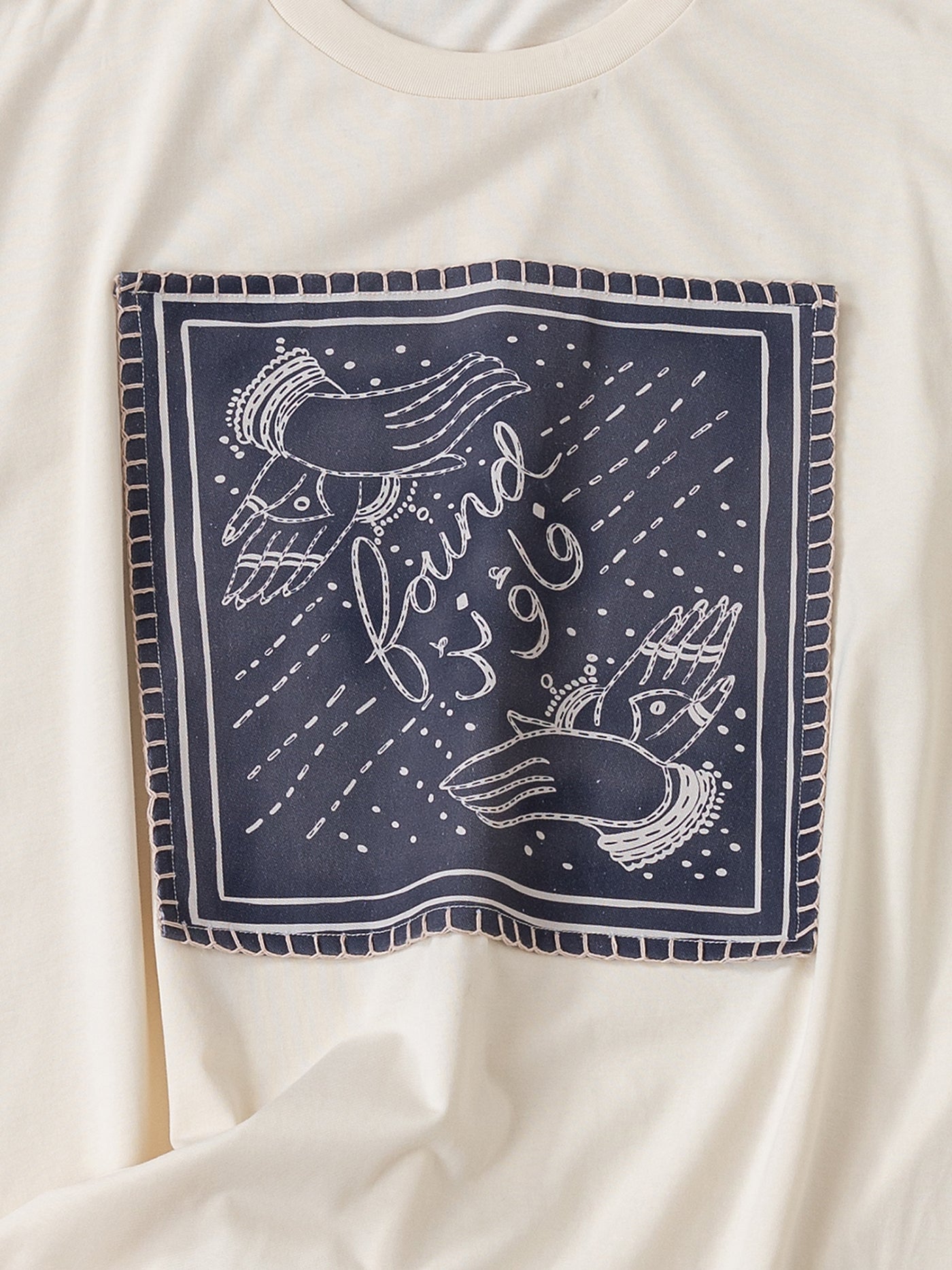 Introducing the "Hand Art Graphic Tee" by FOUND: a white cotton twill shirt adorned with a printed square design featuring two birds and the words "found '96," reminiscent of Mughal paintings.