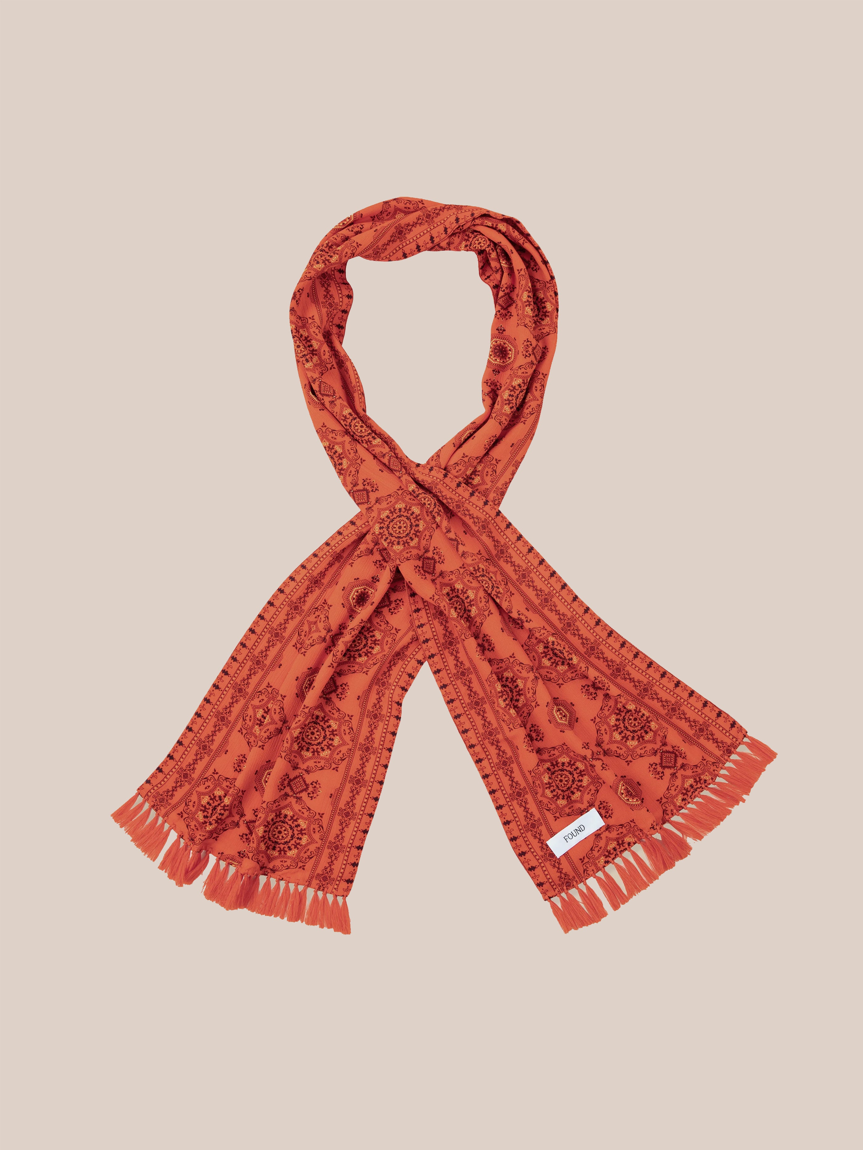 Found's Grenadine Scarf, featuring a floral pattern and hand-tied tassels, arranged in a loop against a neutral background.