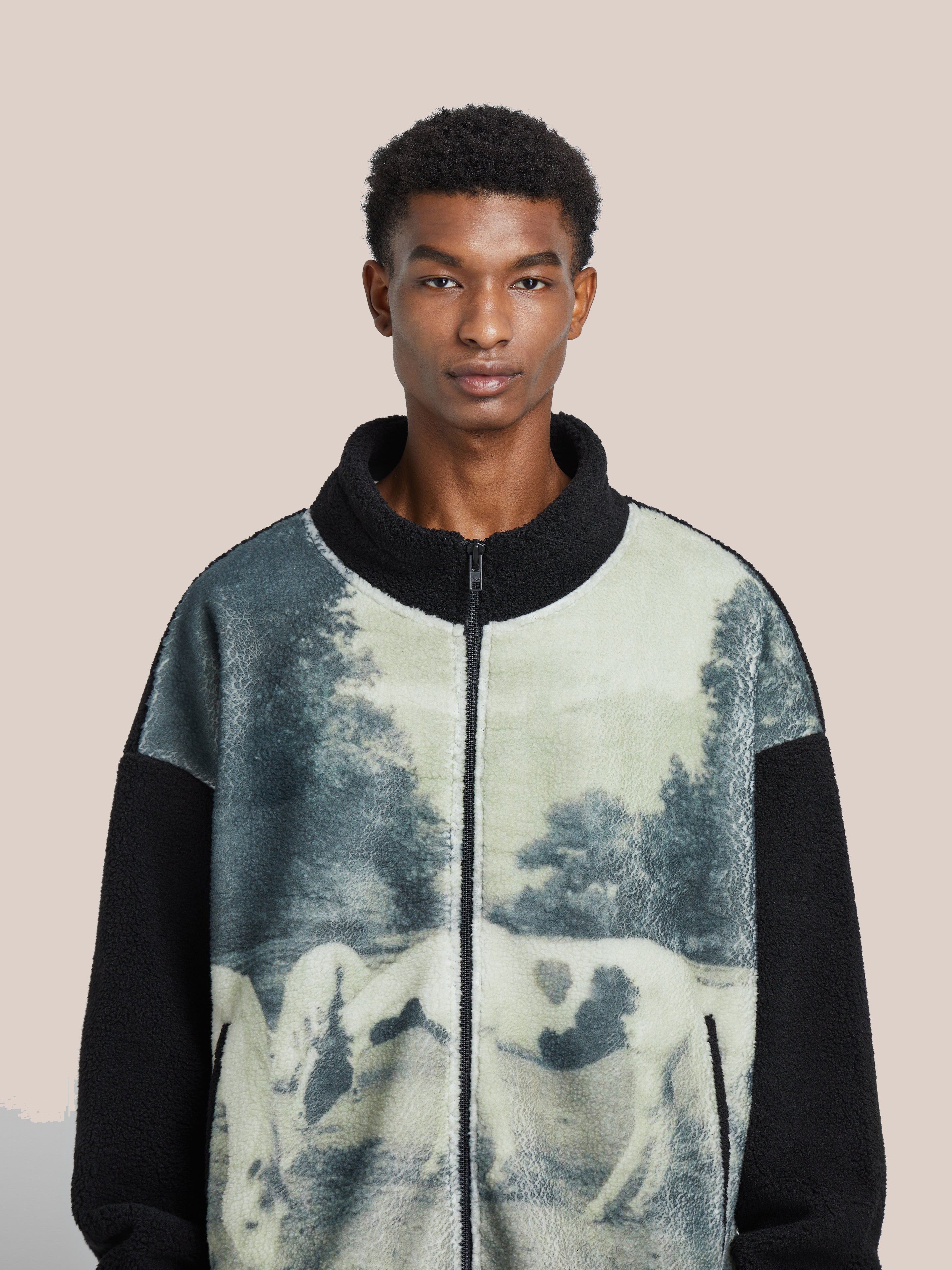 A person wearing the Horses Zip-Up Sherpa Jacket by FOUND, featuring a pastoral sublimation print.