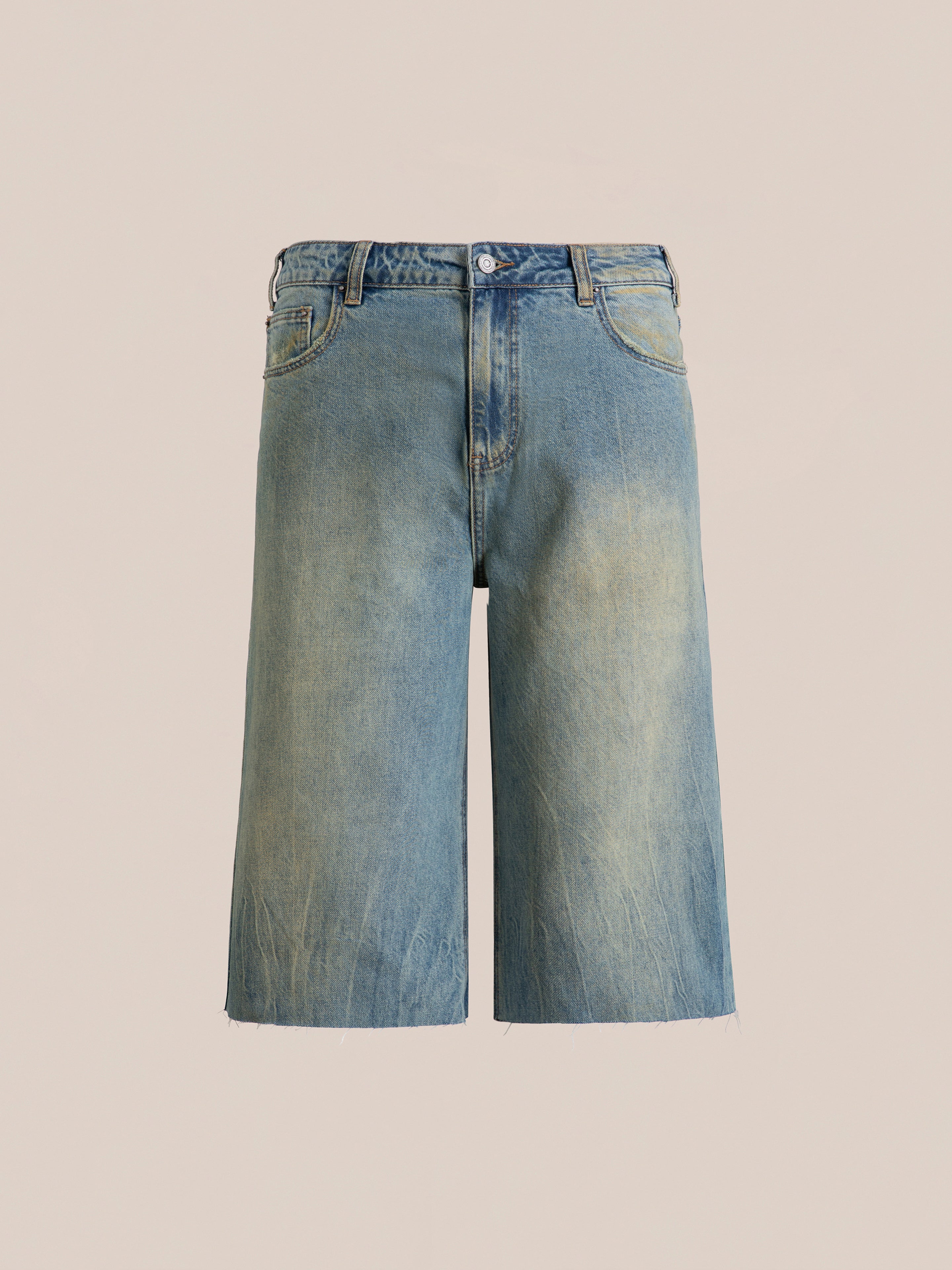 Introducing the Lacy Jean Jorts by FOUND: knee-length, light-washed denim shorts with a button and zipper fly, featuring a distressed and frayed hem.