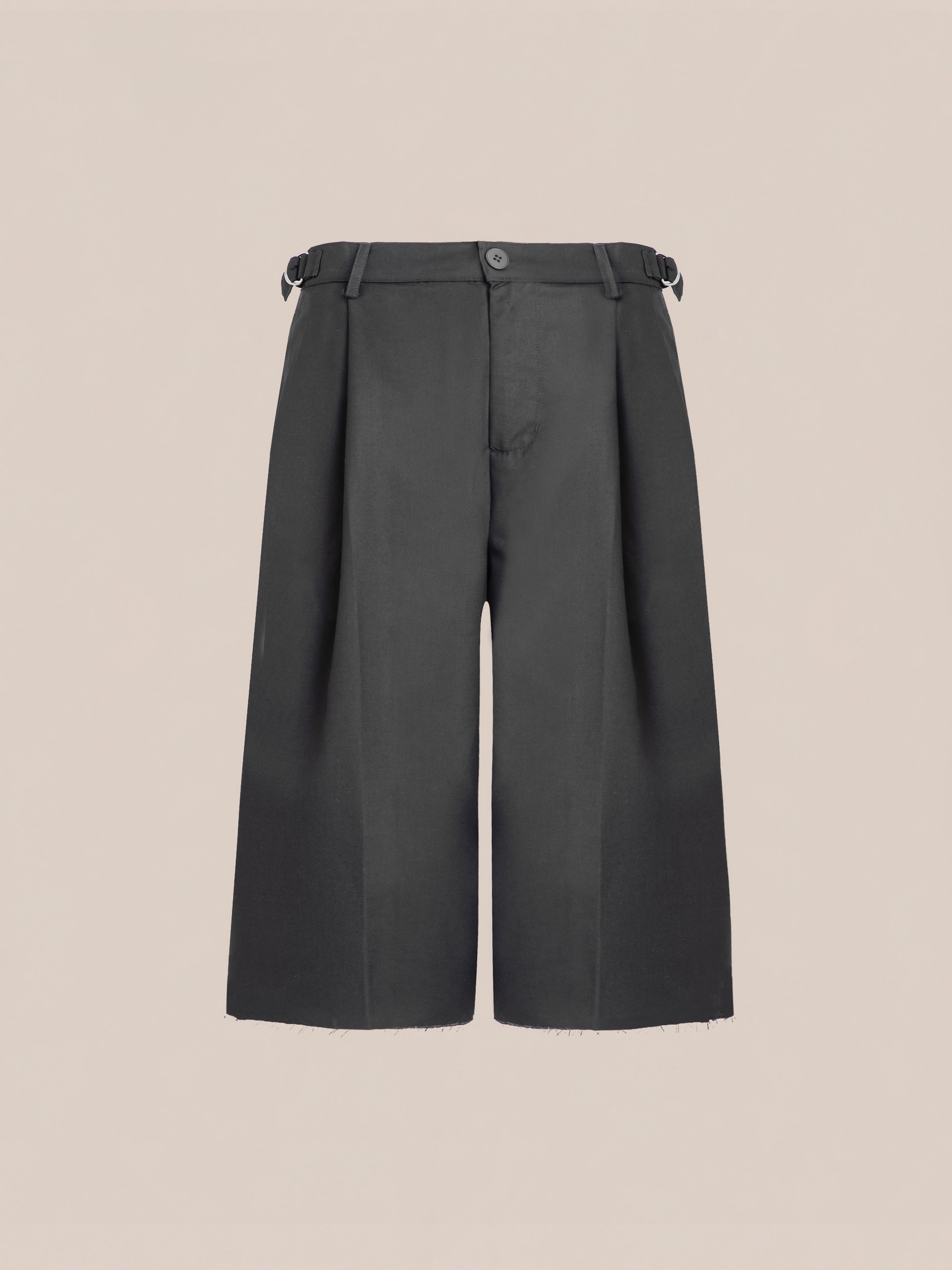 A pair of FOUND Pleated Trouser Shorts in black, featuring wide legs and a mid-length cut with double pleats, a front button closure, and an adjustable waist, set against a plain background.