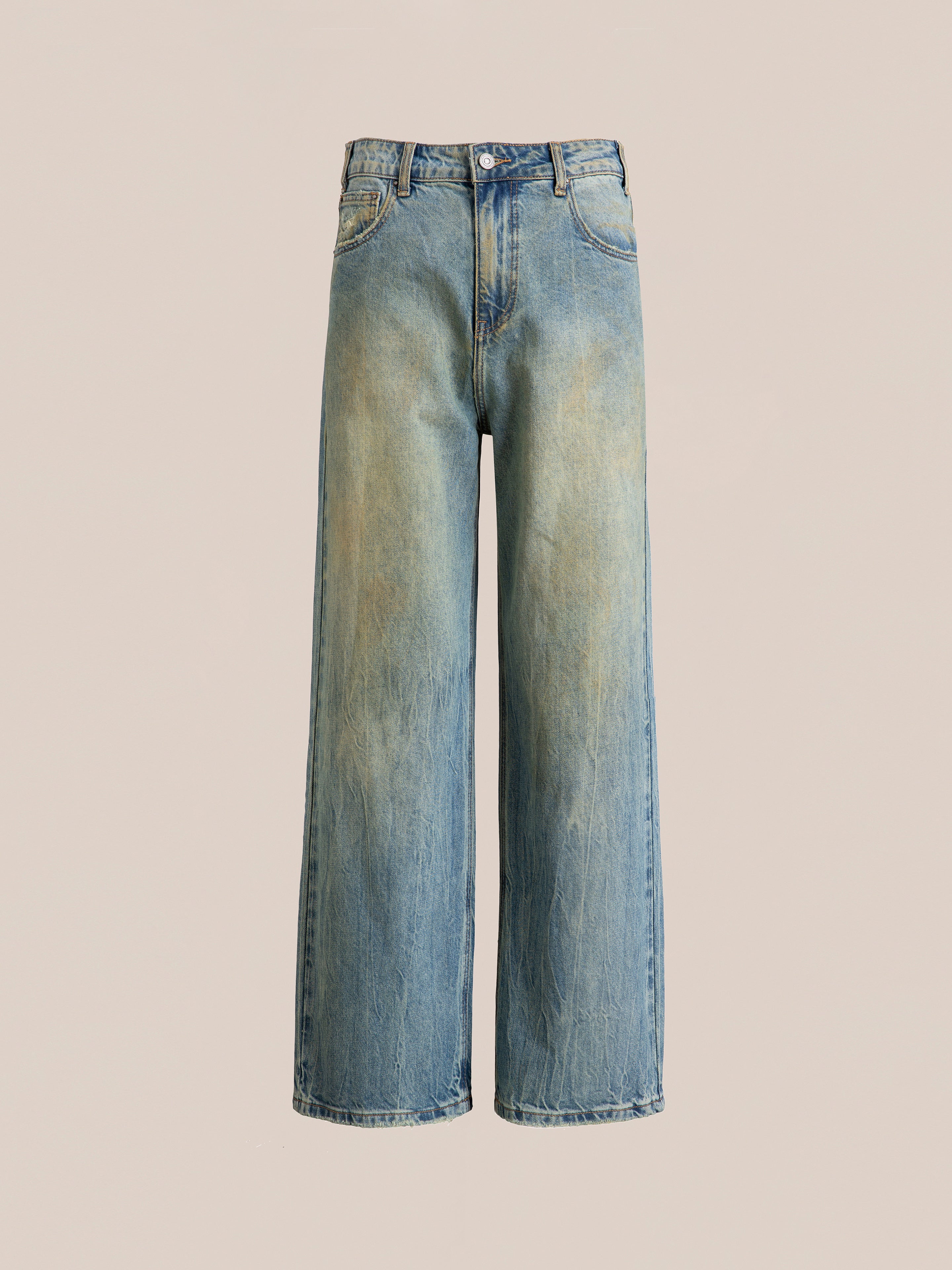 A pair of Lacy Baggy Jeans by FOUND, in a dirty blue wash with light distressing, displayed on a plain beige background.