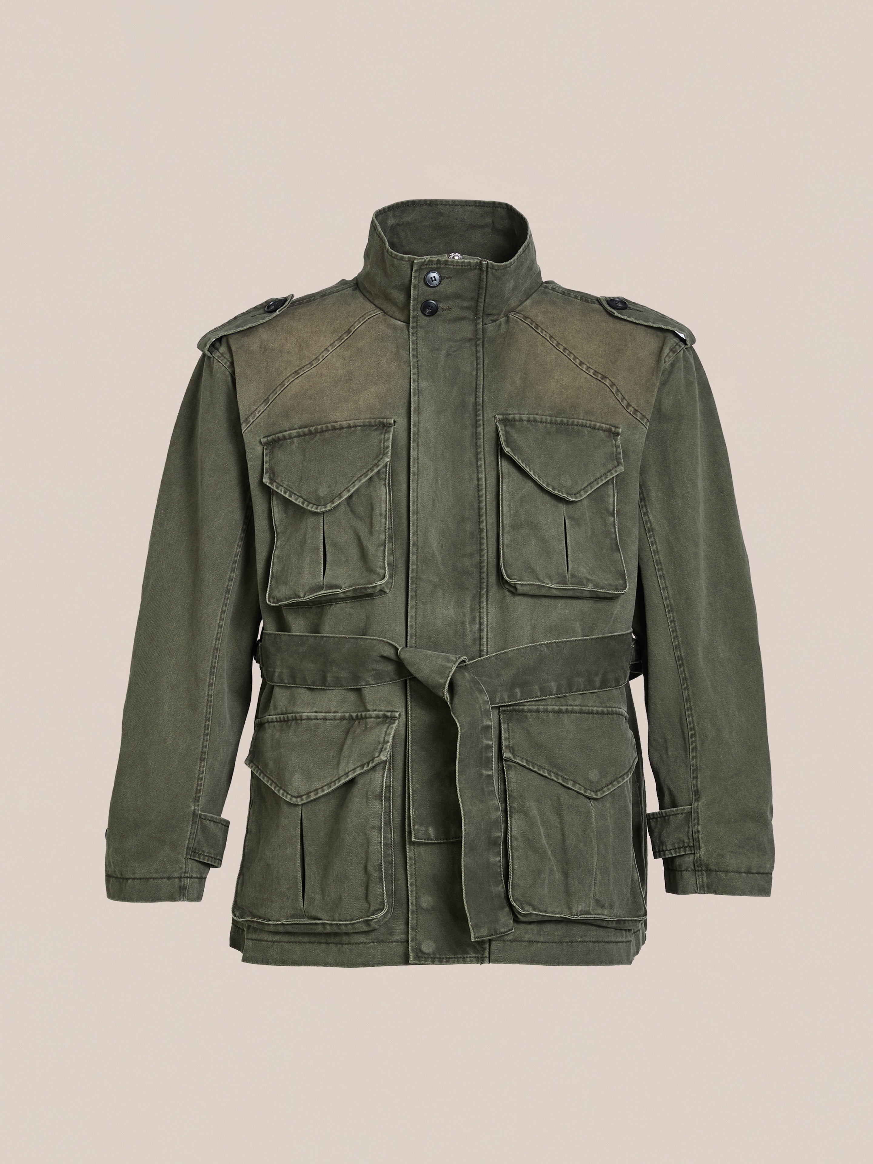 FOUND's M65 Utility Twill Pocket Jacket, in olive green, boasts a high collar and button closure for a vintage vibe. With four flap pockets and a waist belt, it's the ultimate military-inspired outerwear piece.