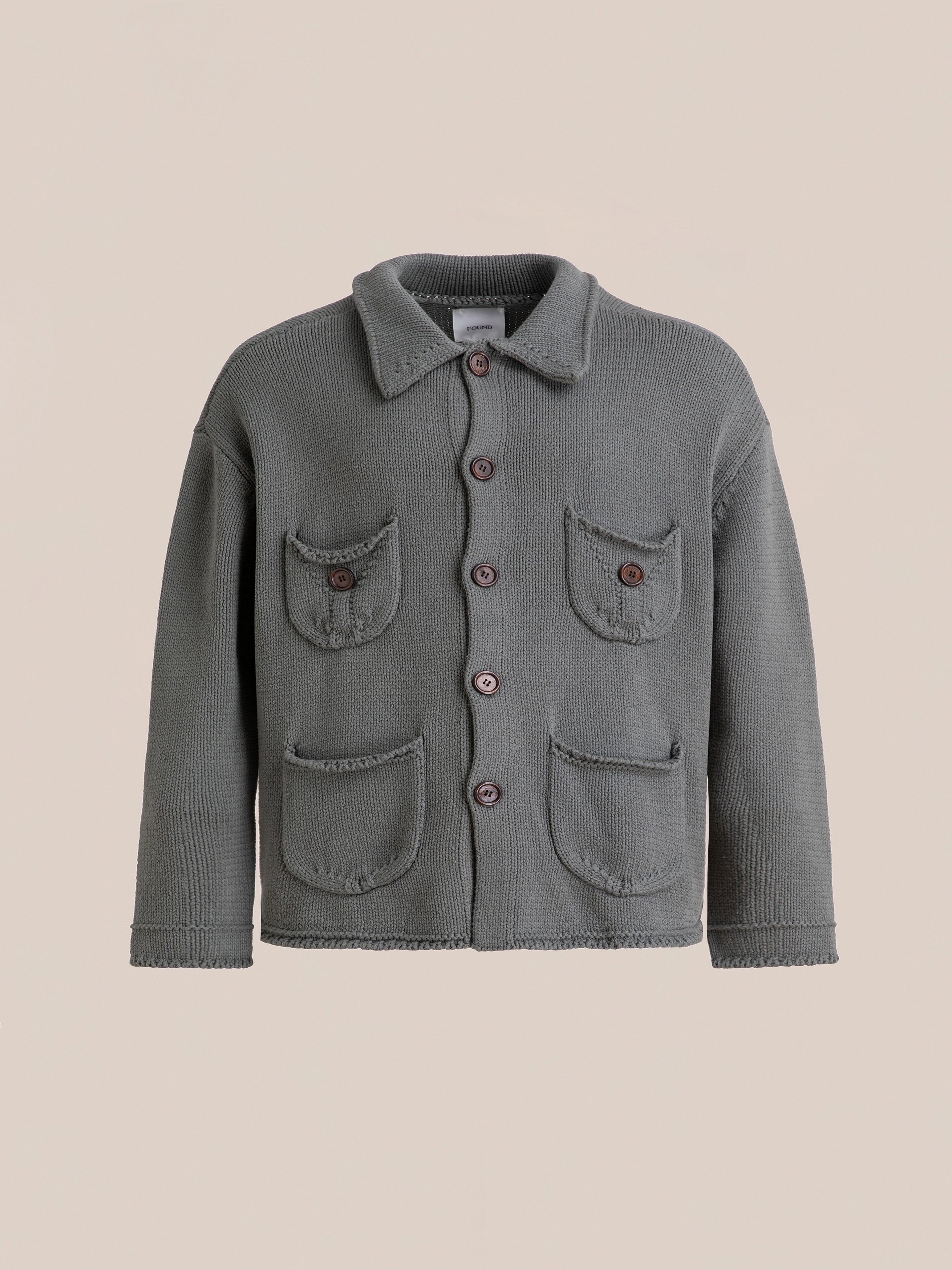 The Hunter Knit Collared Cardigan by FOUND is a gray knit cardigan with charming wooden buttons and four front pockets, displayed on a plain background.