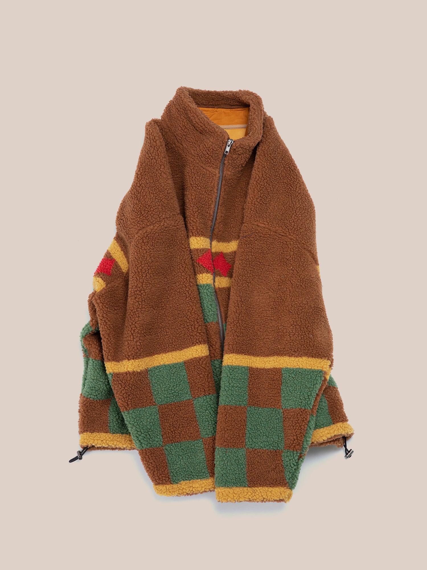 Introducing the Checkered Zip-Up Sherpa by FOUND: a brown fleece jacket featuring a vibrant jacquard checkered pattern of green and yellow squares with red accents, set against a plain background.