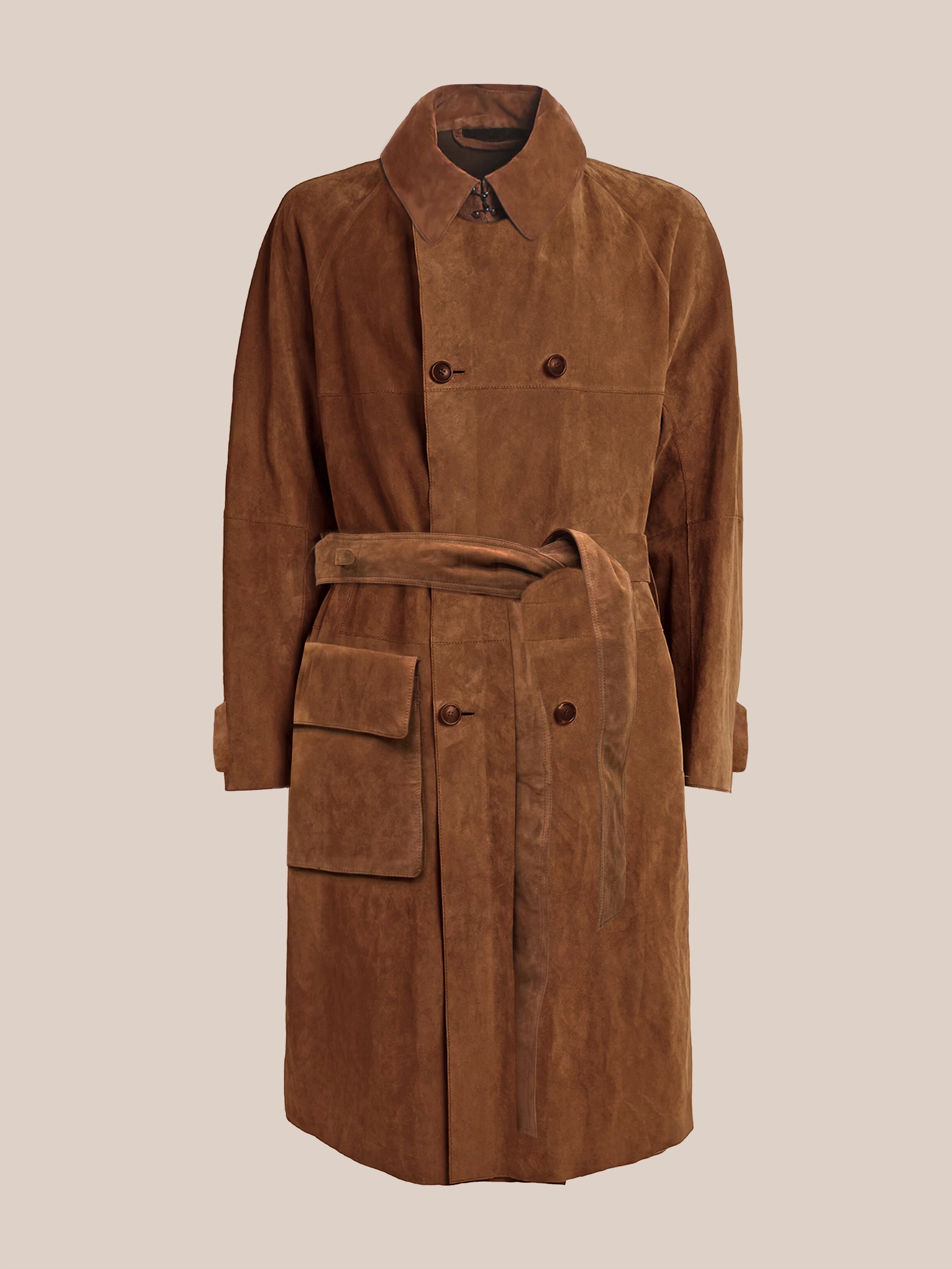 The FOUND Suede Leather Trench Coat is unisex, crafted in Pakistan with brown suede leather. It features a wide collar, double rows of buttons, a matching belt, an adjustable sleeve strap for versatile style, and has one large side pocket.