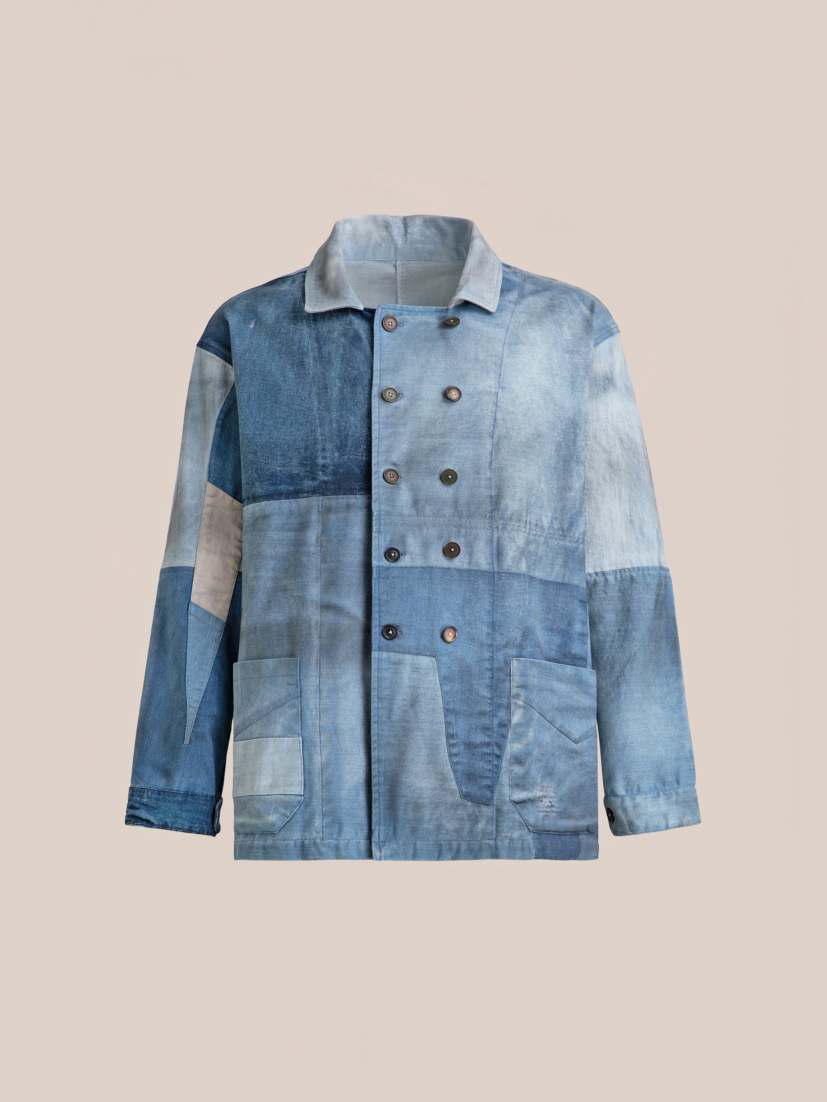 The FOUND Multi Patch Painters Work Jacket is a denim patchwork jacket with a double-breasted front, featuring various shades of blue and gray patches, reminiscent of an antique French painters work jacket.