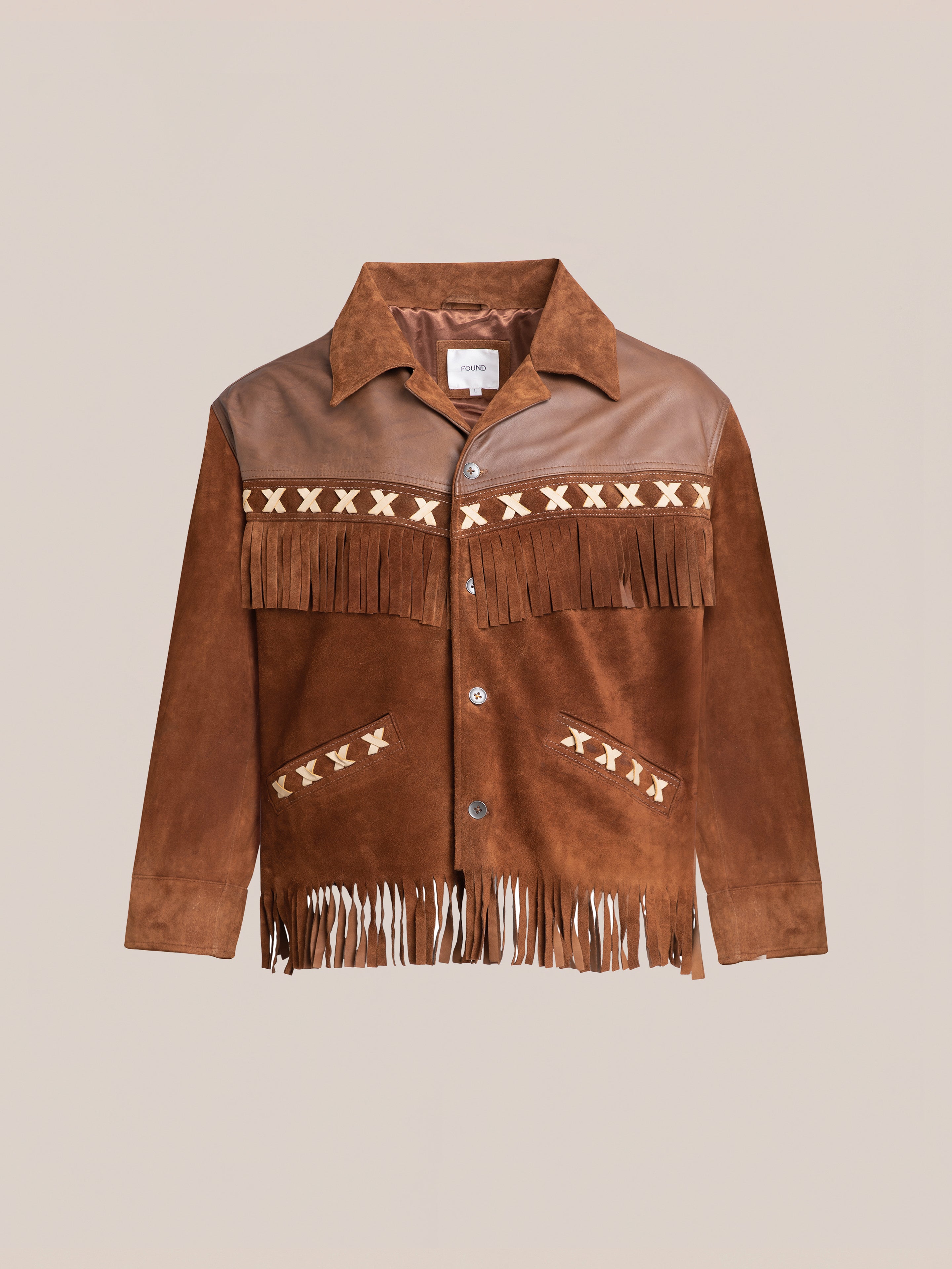 FOUND's Western Fringe Suede Leather Jacket, crafted from ethically sourced materials, features brown suede with fringes and patterned details on the chest and pockets, displayed on a plain background.